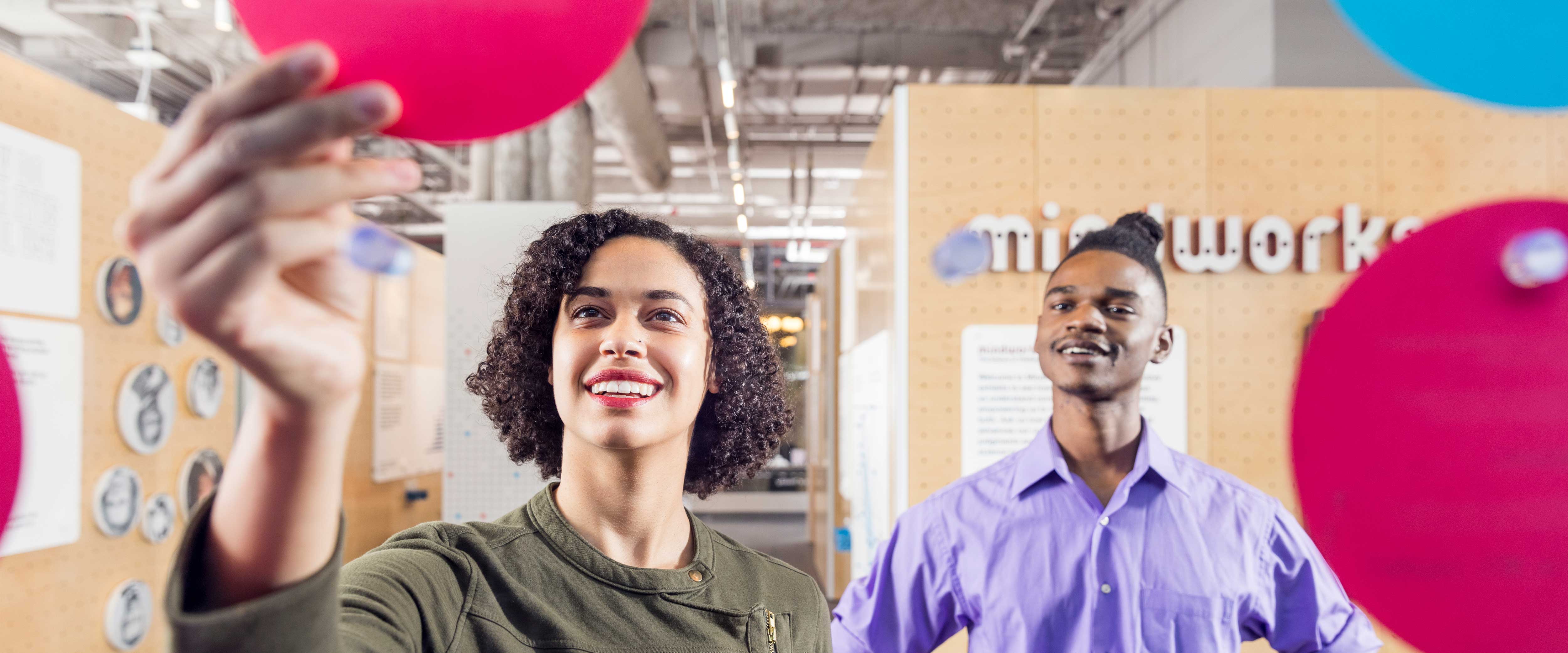 Woman hanging her disc with a man in the background
