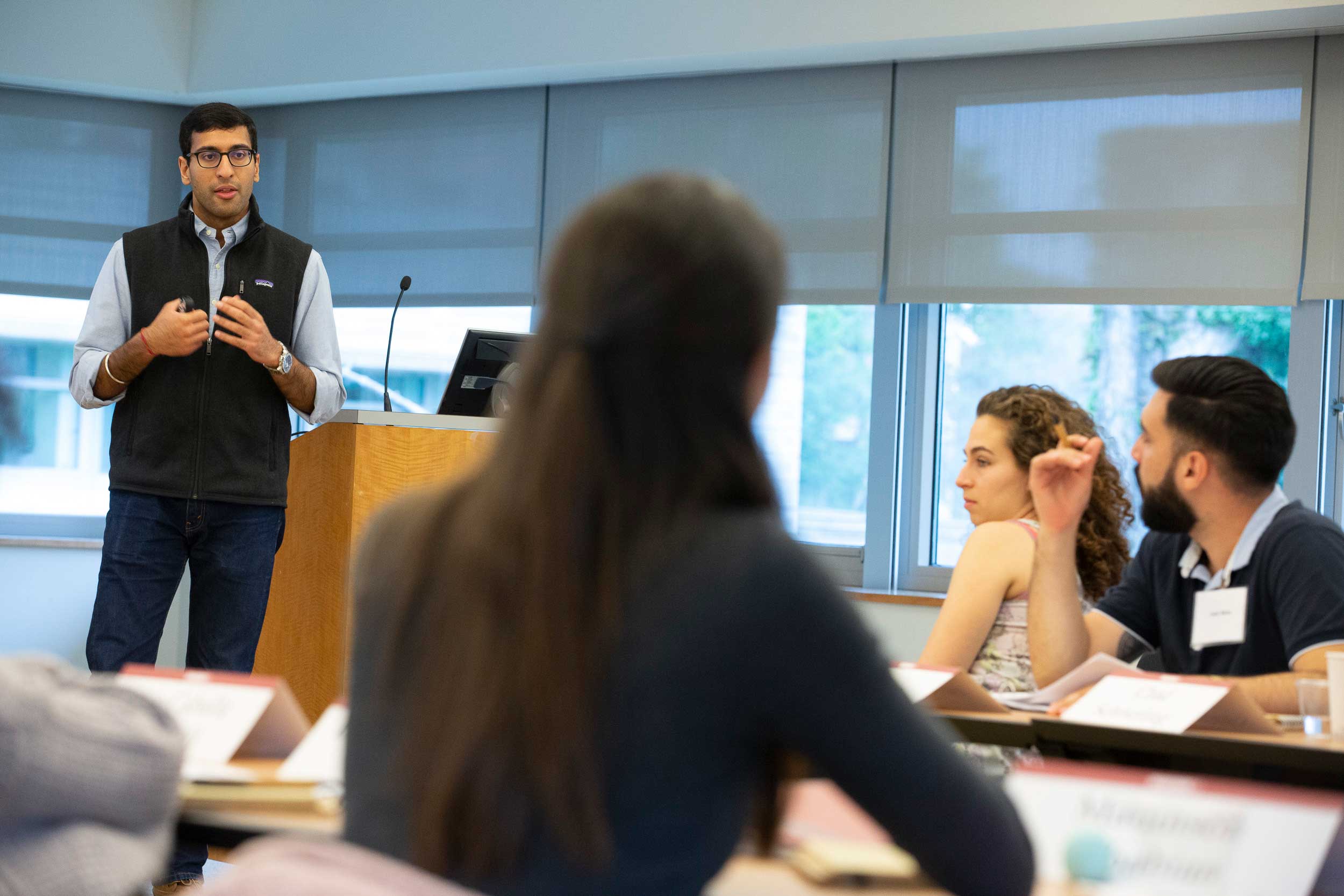 Professor engaging in discussion with his finance students