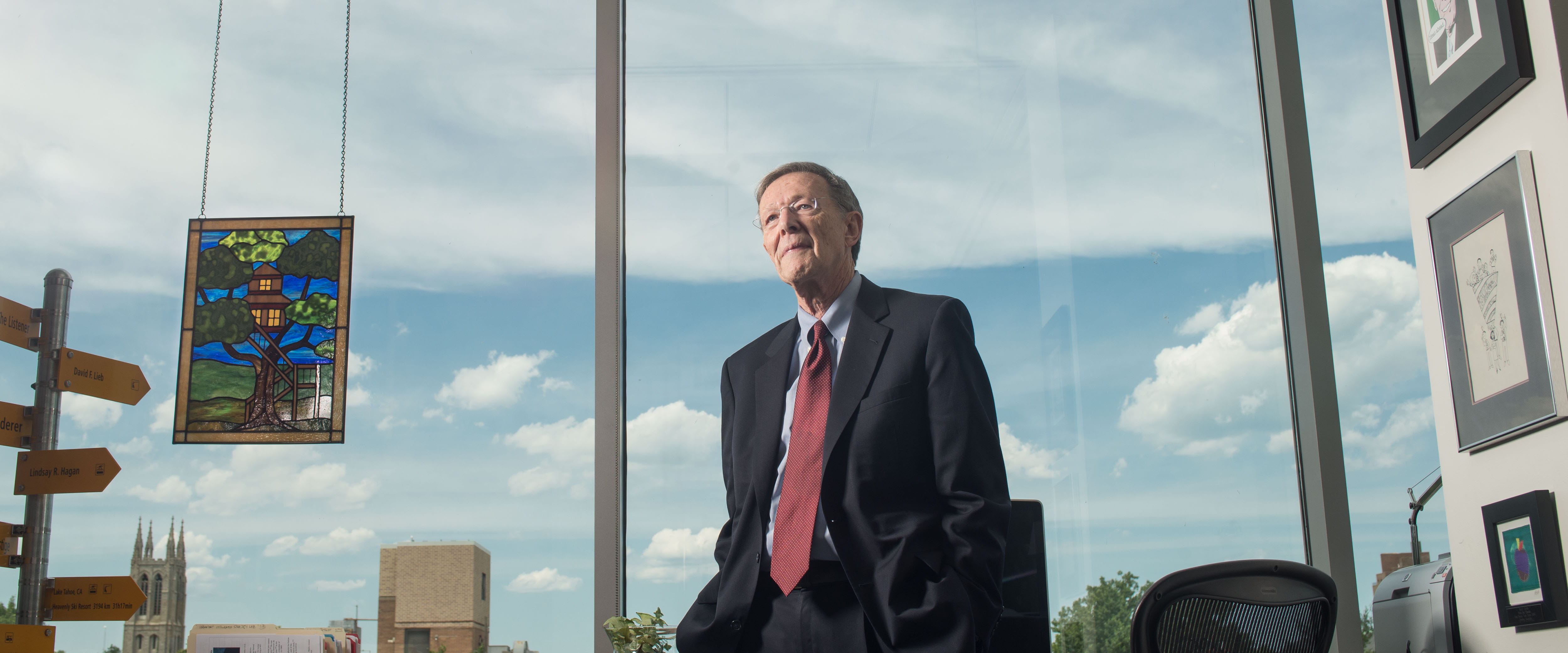 Harry Davis posing in front of his office desk