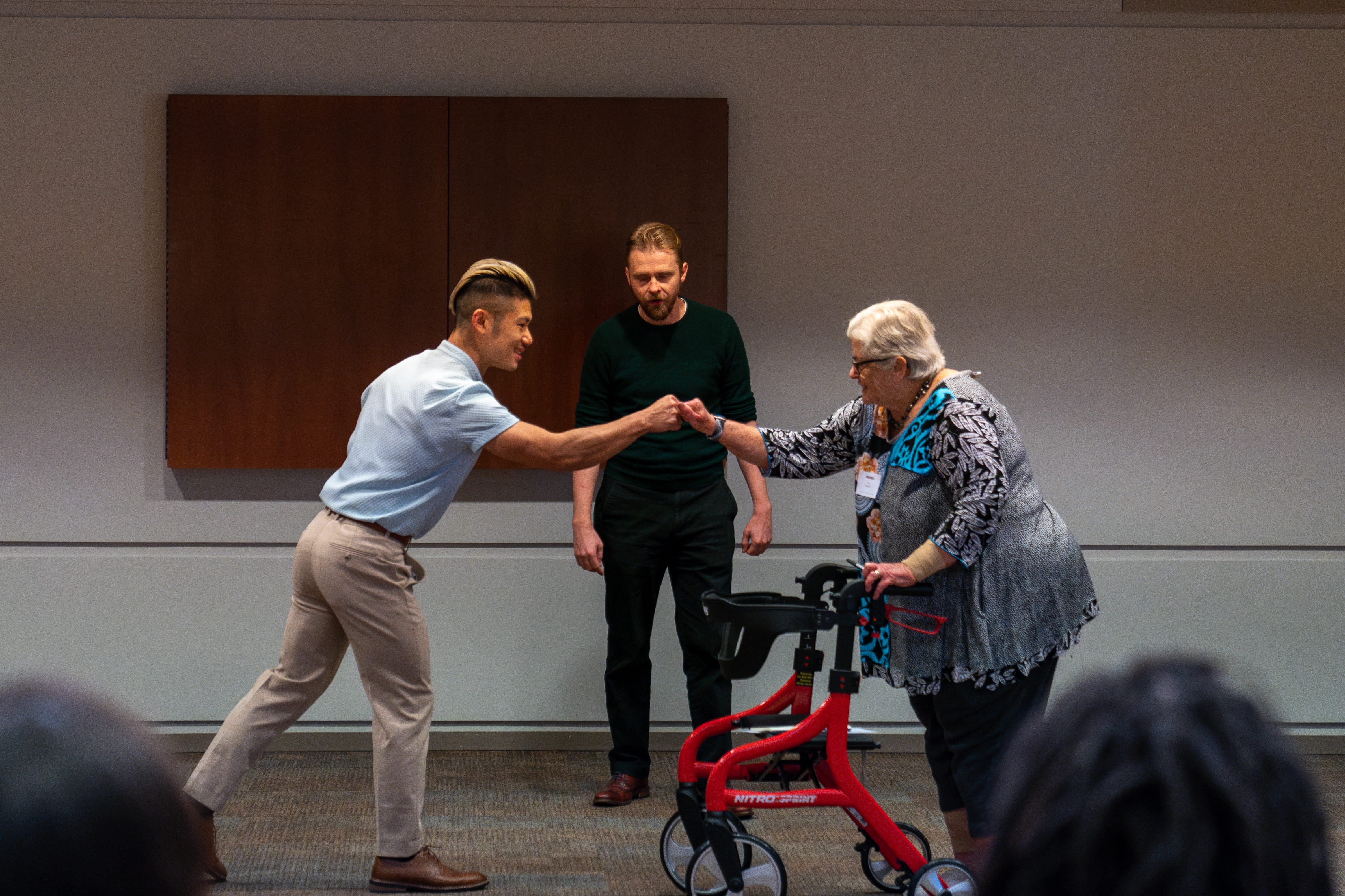 Participants fist-bump in an acting exercise