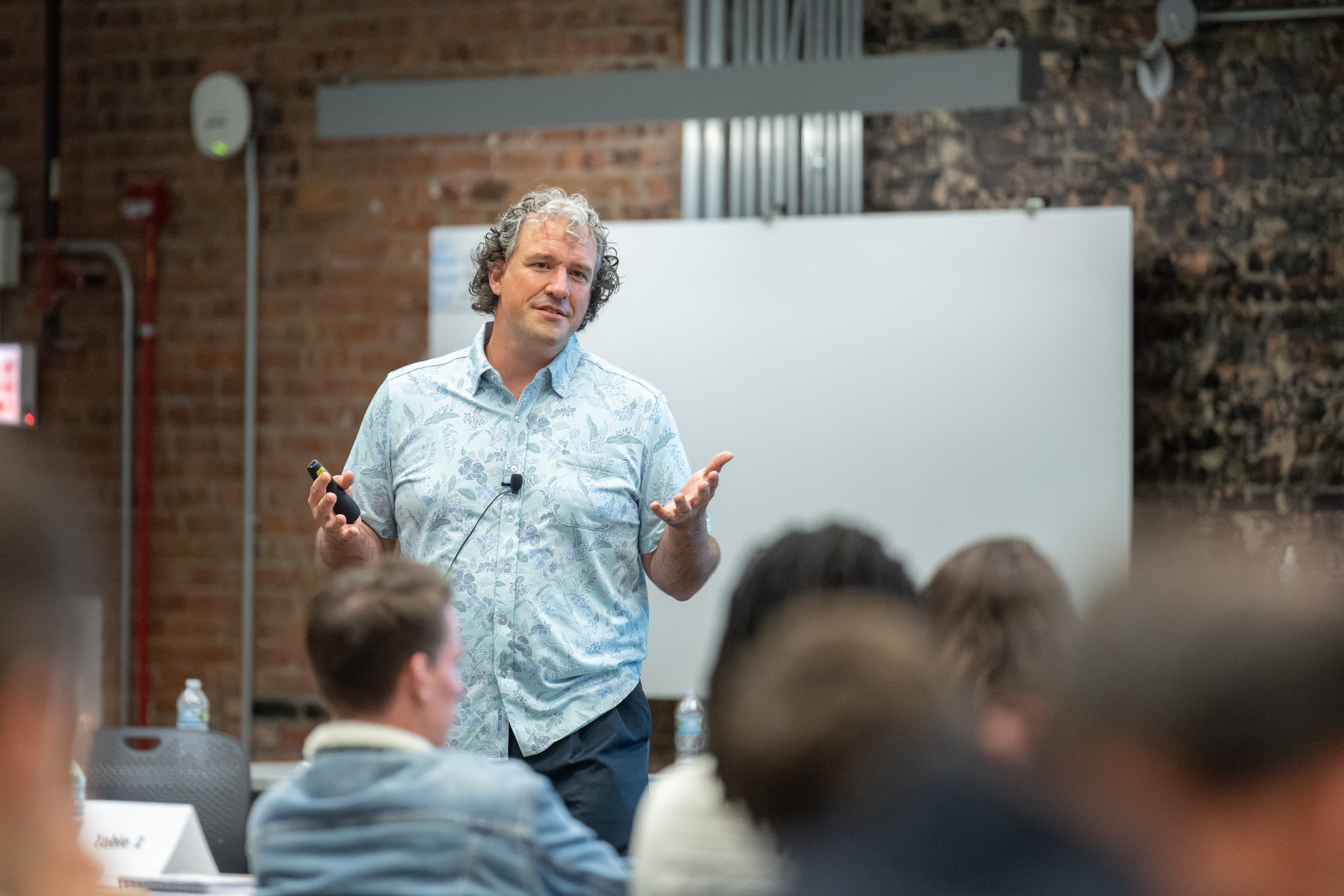 Nick Epley presents in front of a whiteboard