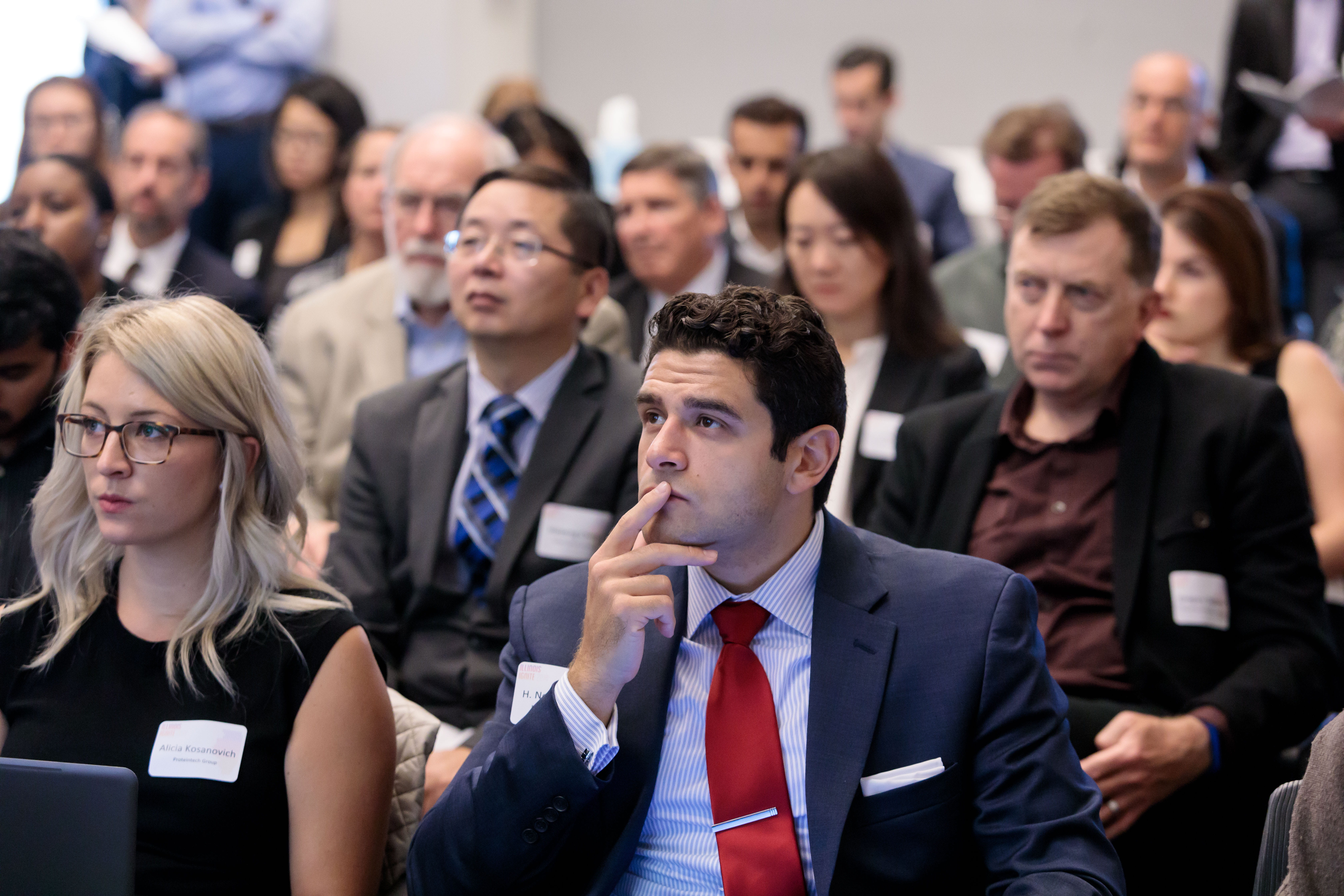 Audience members watch a conference session