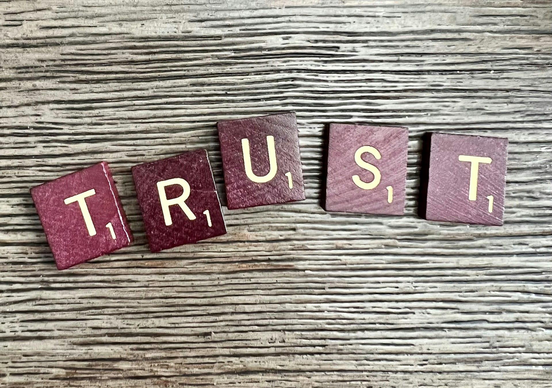Scrabble tiles spelling the word "trust"
