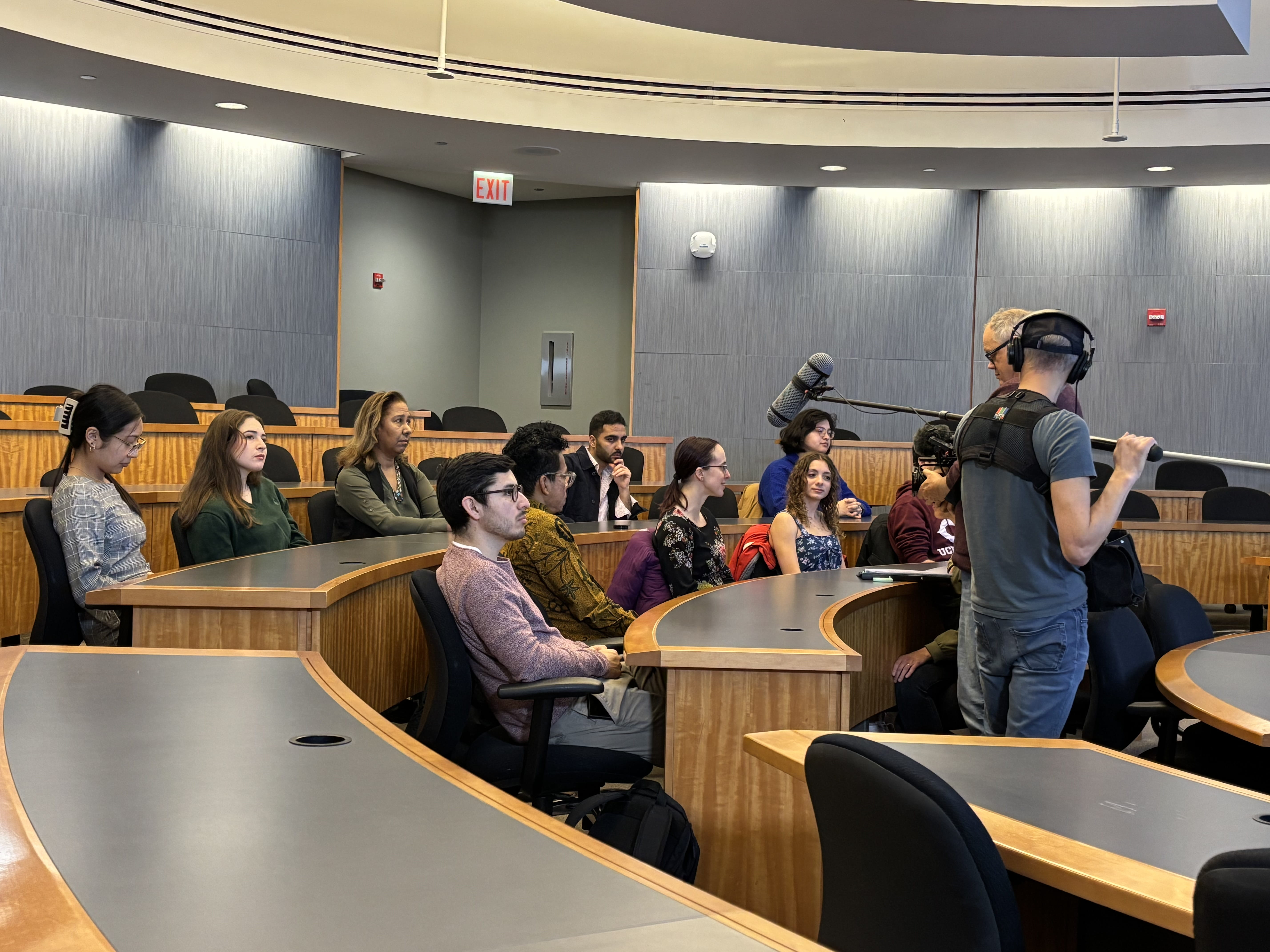 Students in a lecture hall recorded by a film crew 