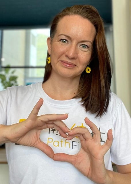 Woman holding her hands in the shape of a heart