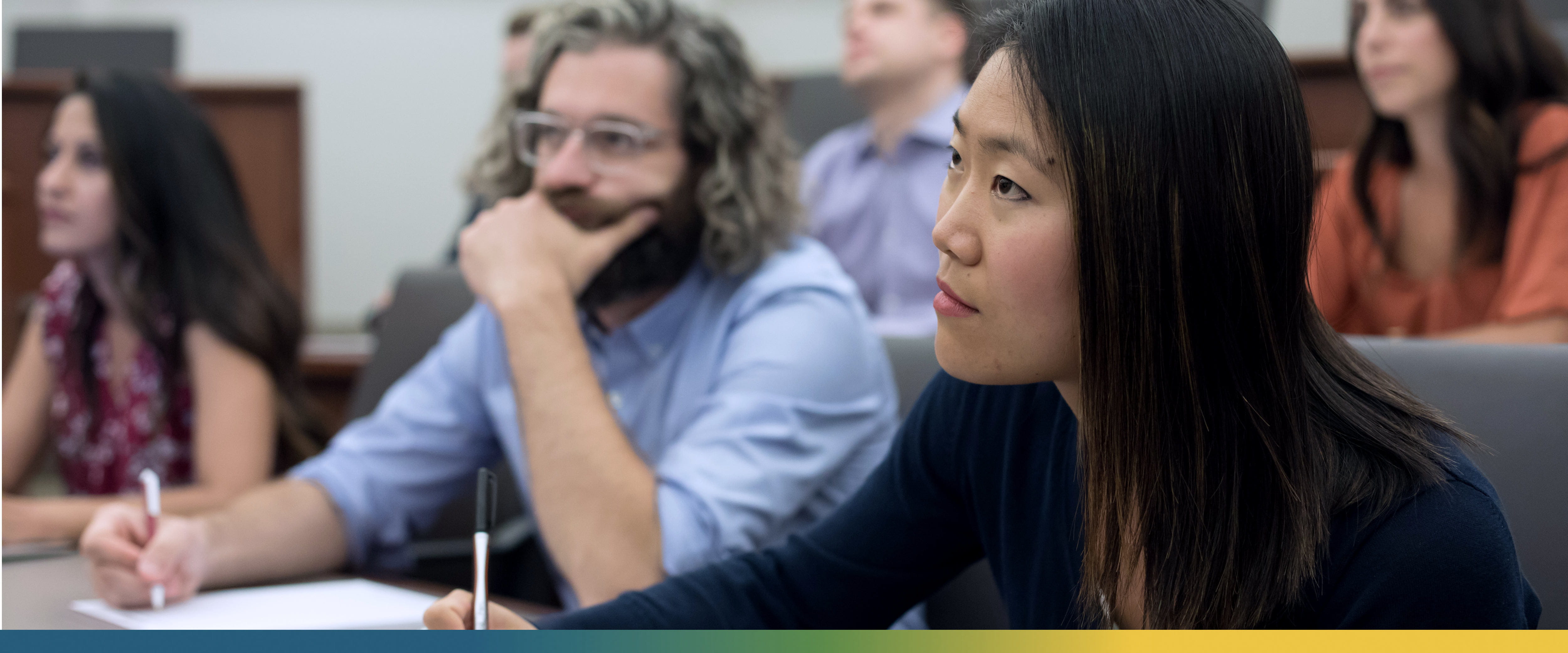 Civic Scholars in a classroom taking notes