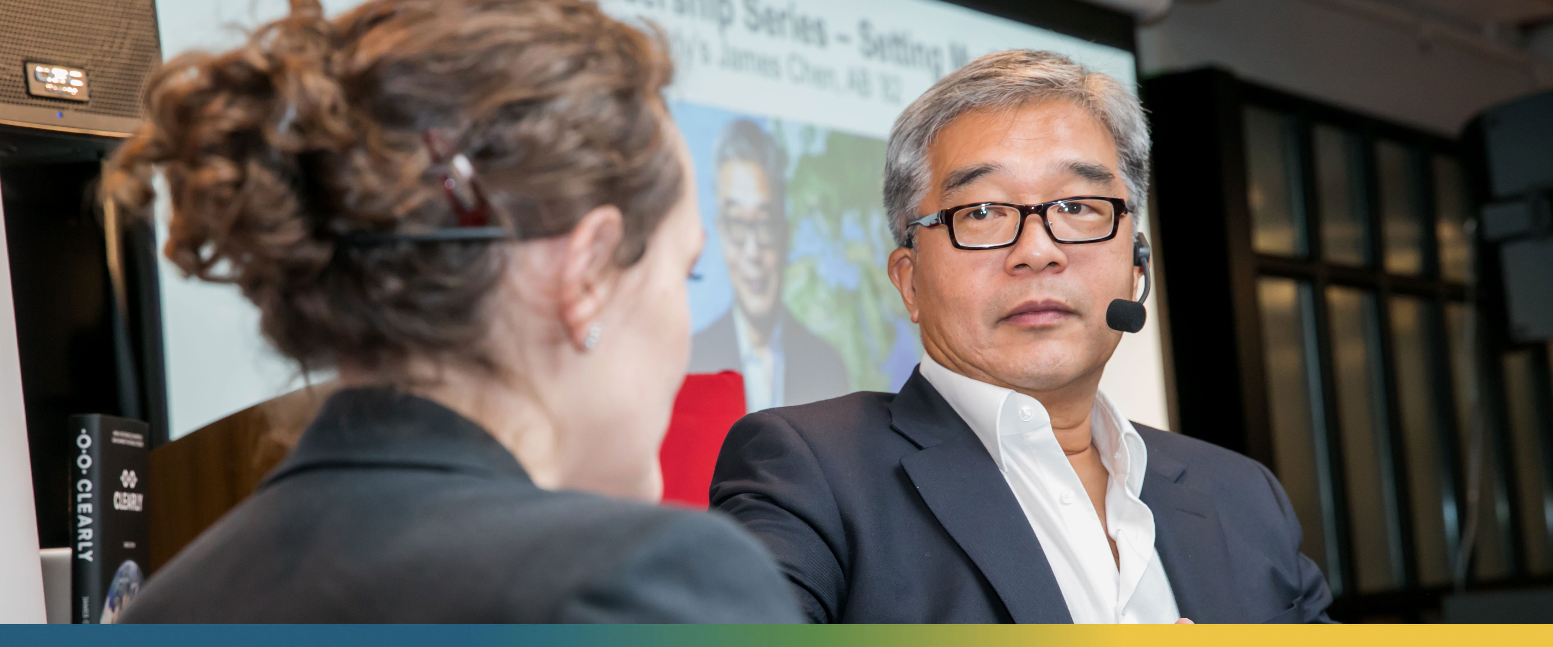 James Chen sitting on stage opposite a colleague during a workshop about his book “Clearly: How a 700 Year Old Invention Can Change the World Forever”
