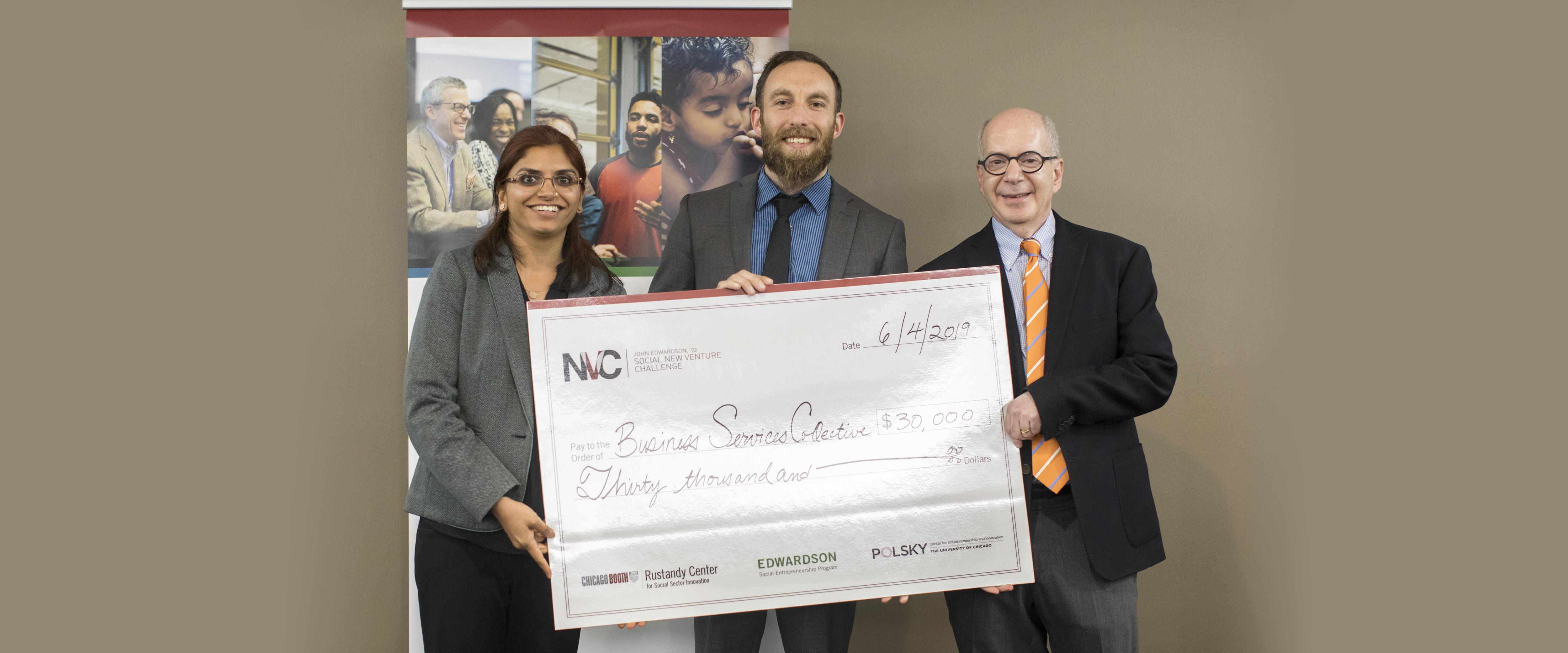 Business Services Collective co-founders posing with their giant check after winning at the 2019 SNVC