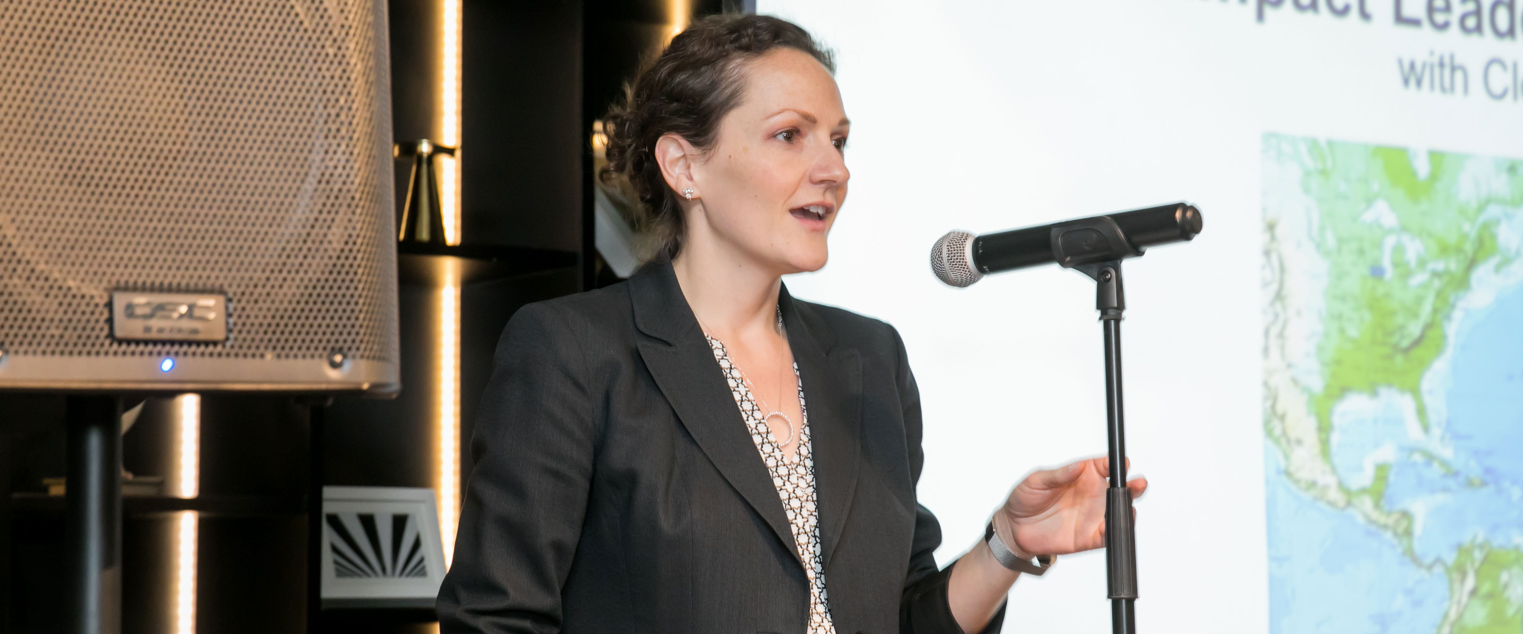 Christina Hachikian speaking in front of a microphone