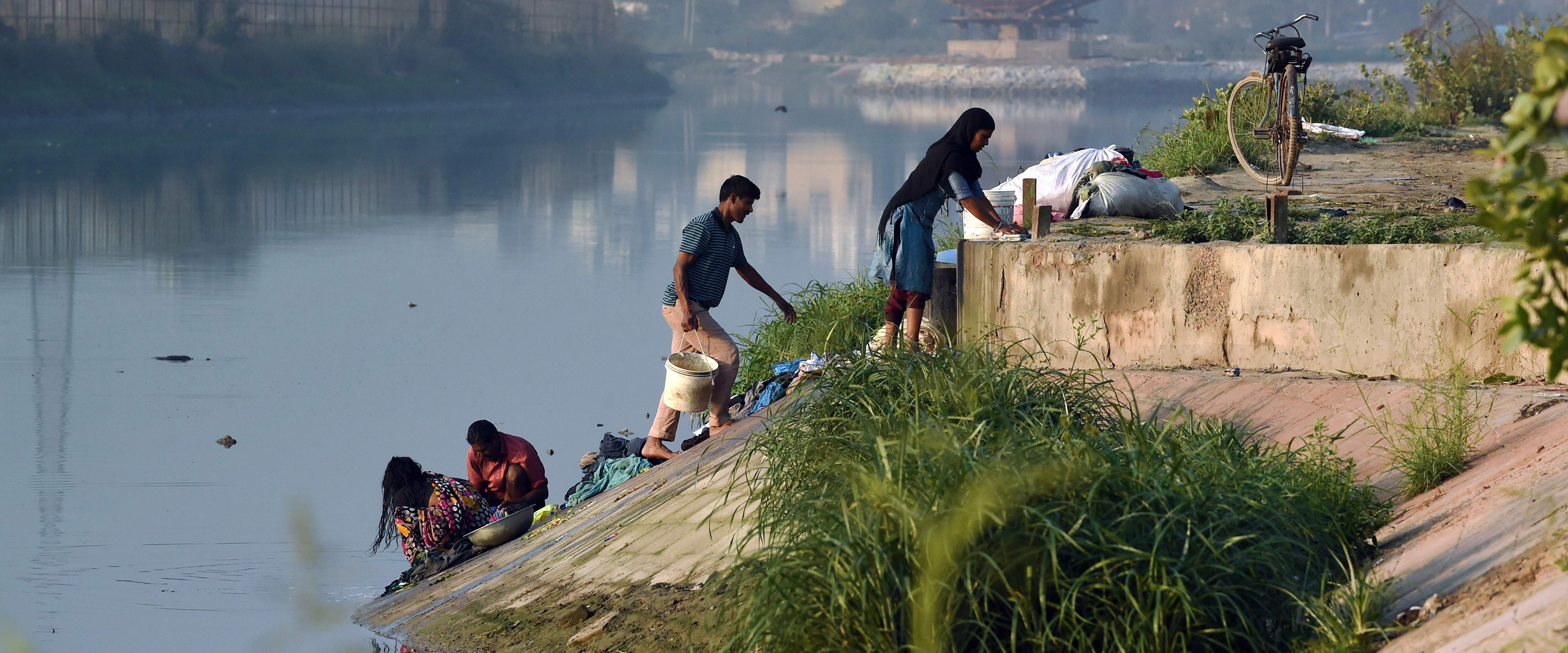 A group of people near a river in India