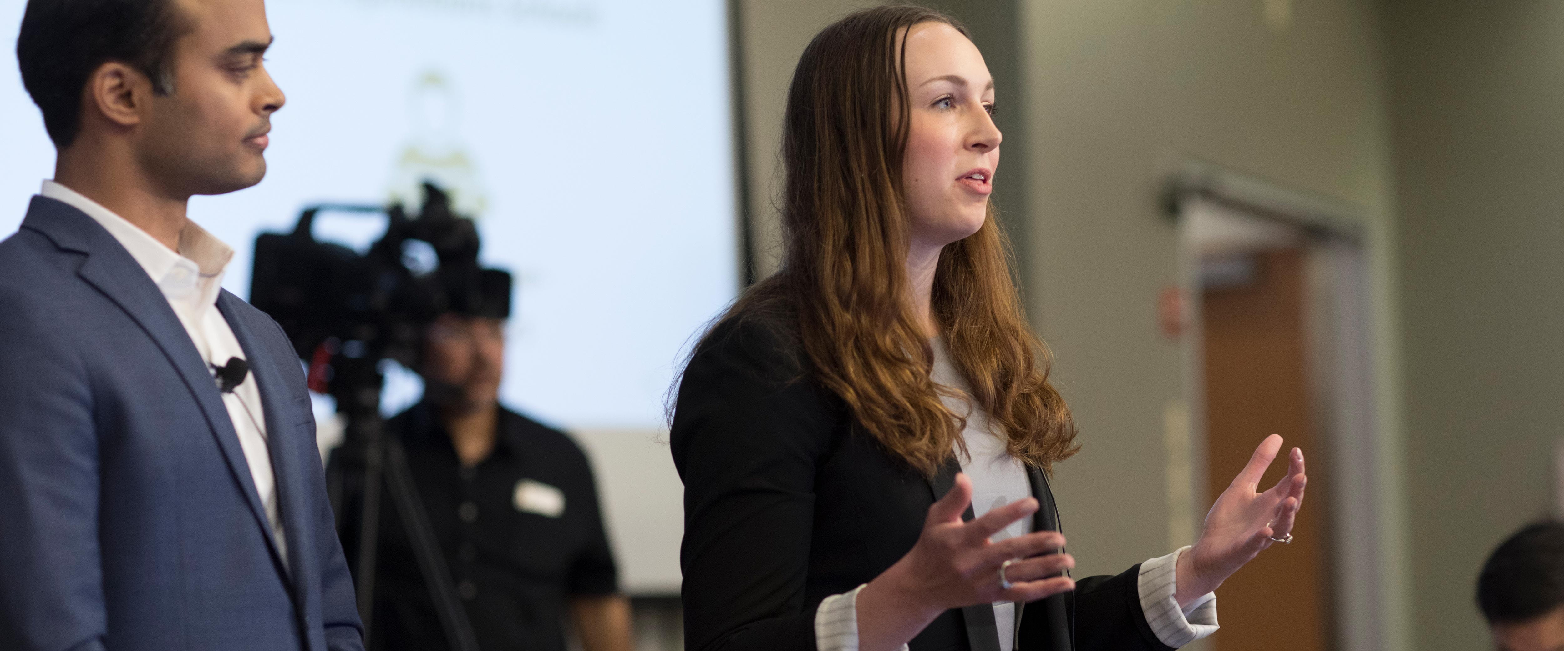 Two speakers at an SNVC 2019 presentation