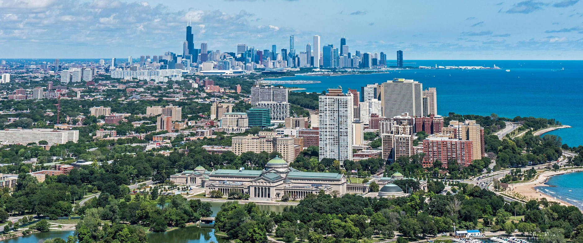 Skyline of Chicago from the south featuring the Museum of Science and Industry in the foreground