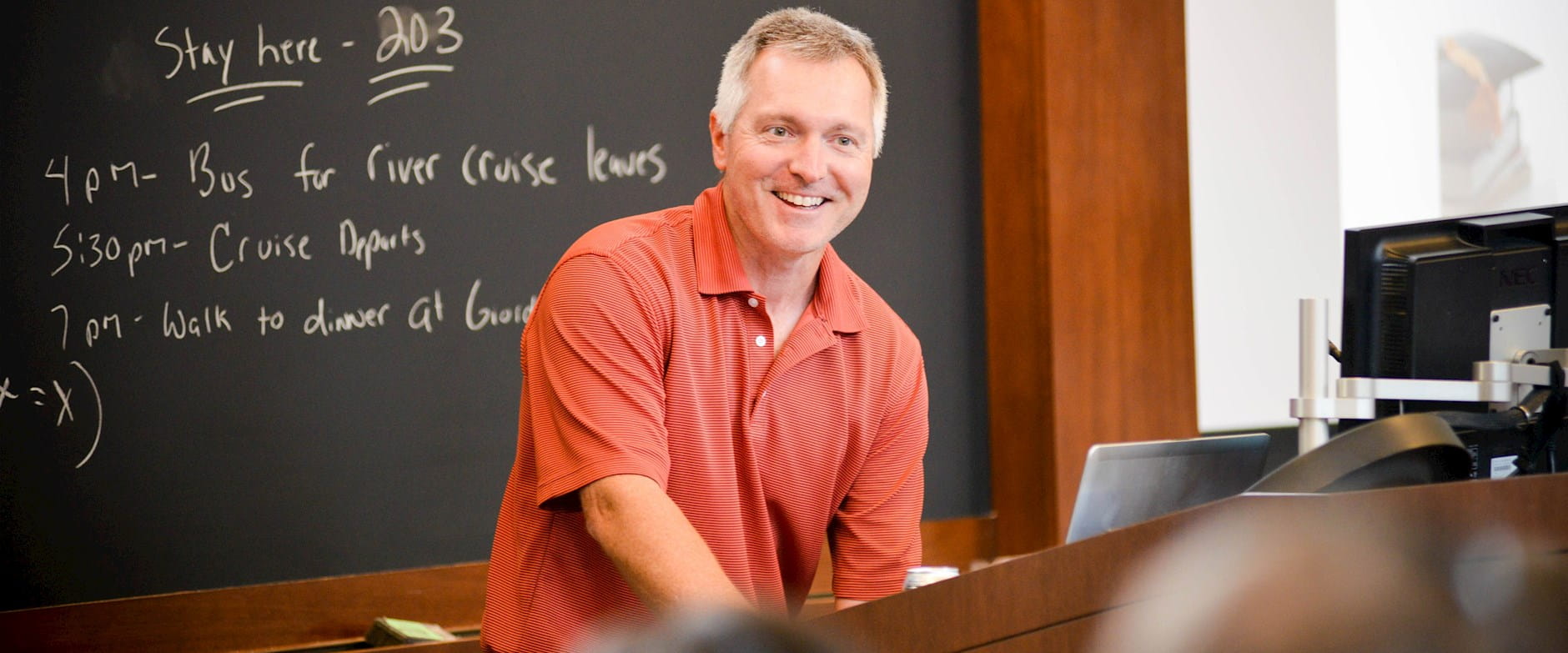 John List teaching in front of a chalkboard