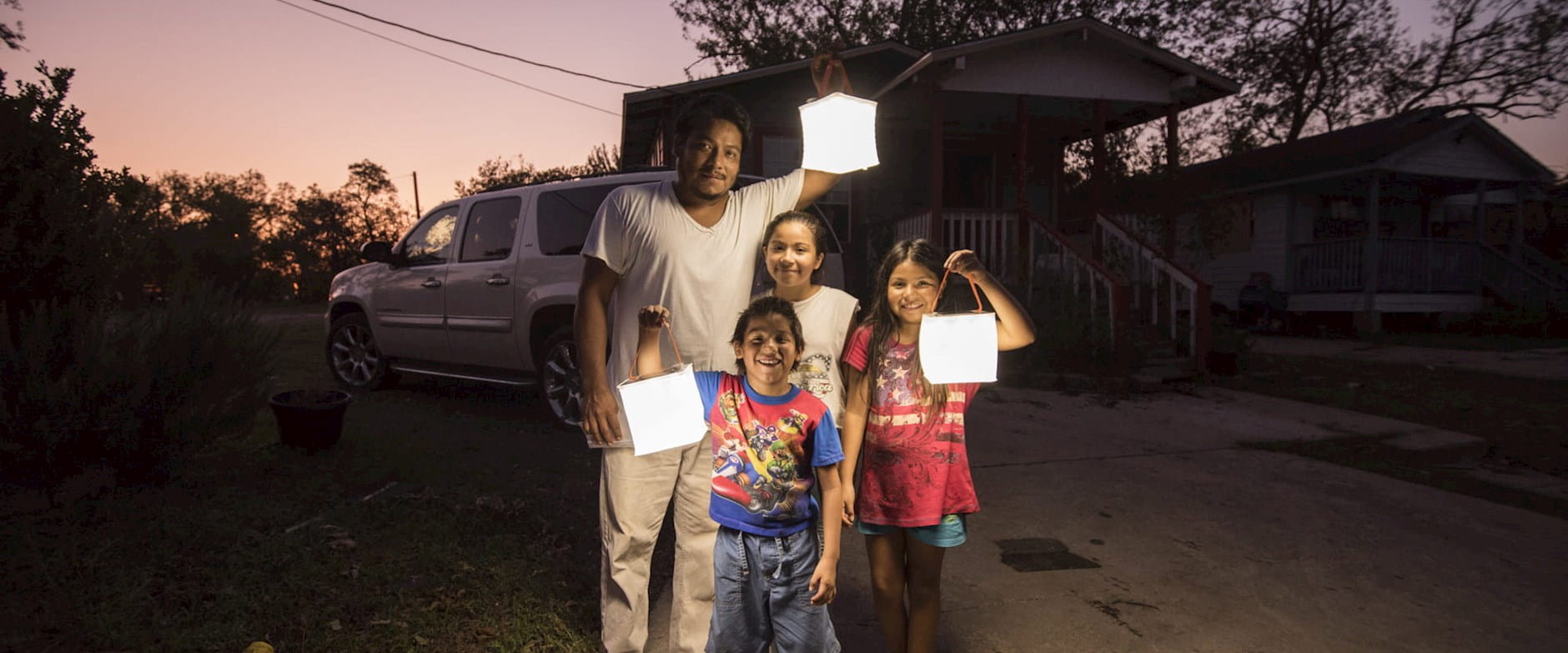This is an image of a family in Houston using a LuminAID lantern