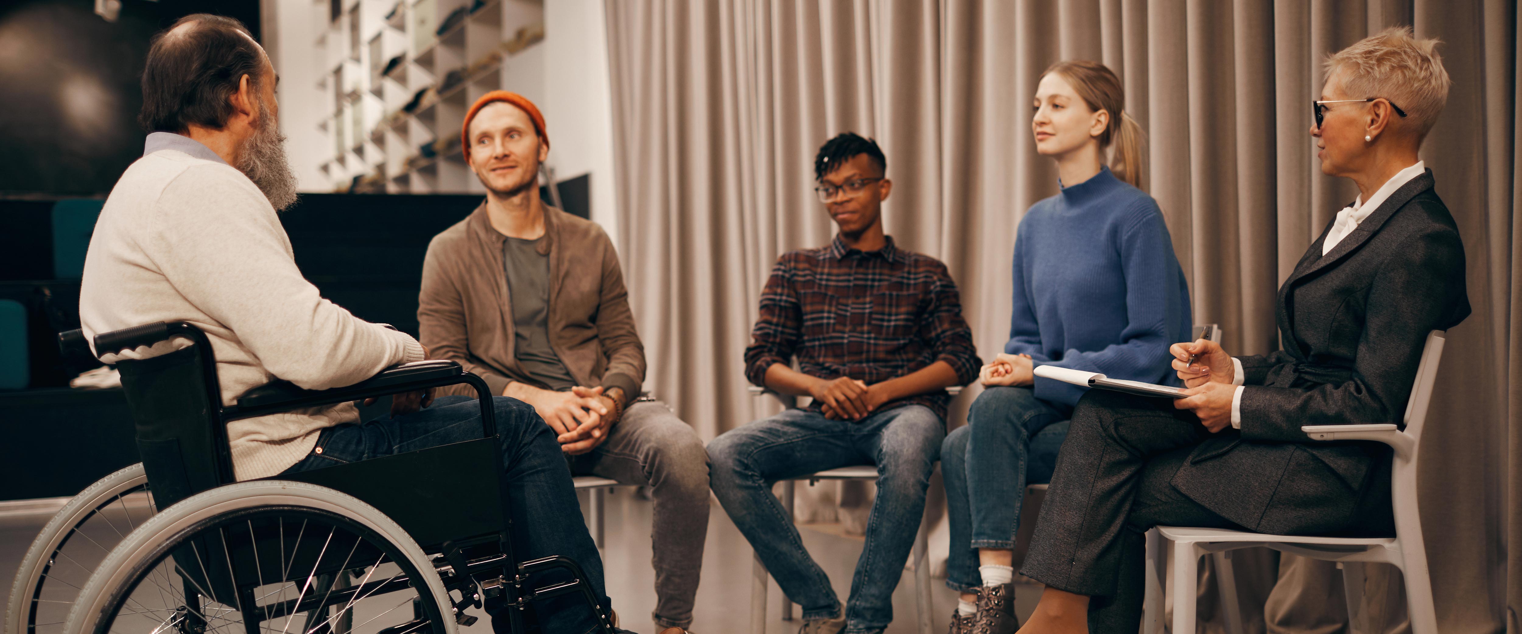 Five people in a semi-circle seated during a meeting