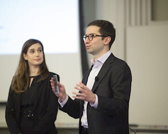 This is an image of George Boghos, ’18, and Frankie Schiller, MBA ’19, AM ’19, presenting their startup idea, AIM Clinics, in the John Edwardson, ’72, Social New Venture Challenge in spring 2018.