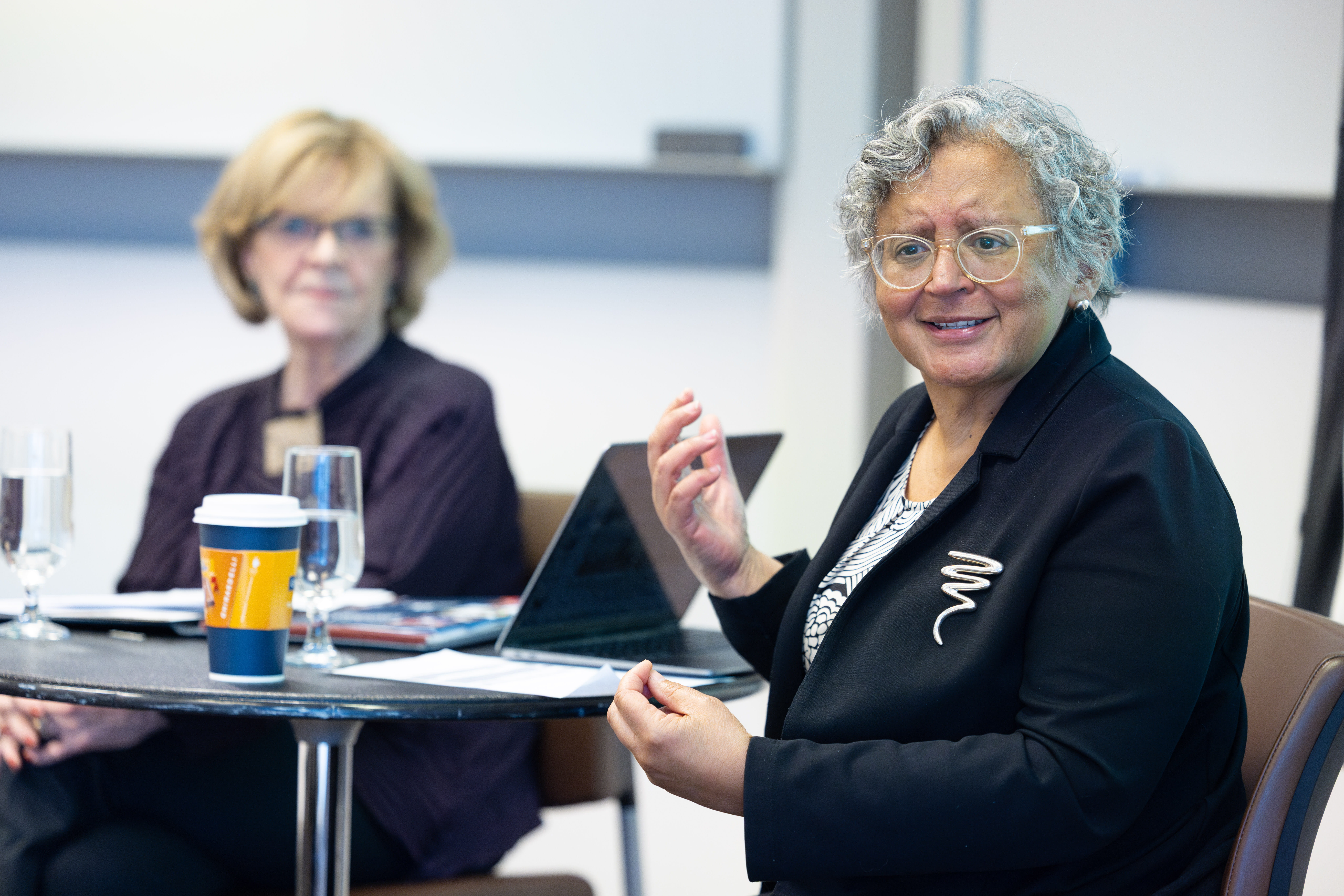 Two women sit at a table