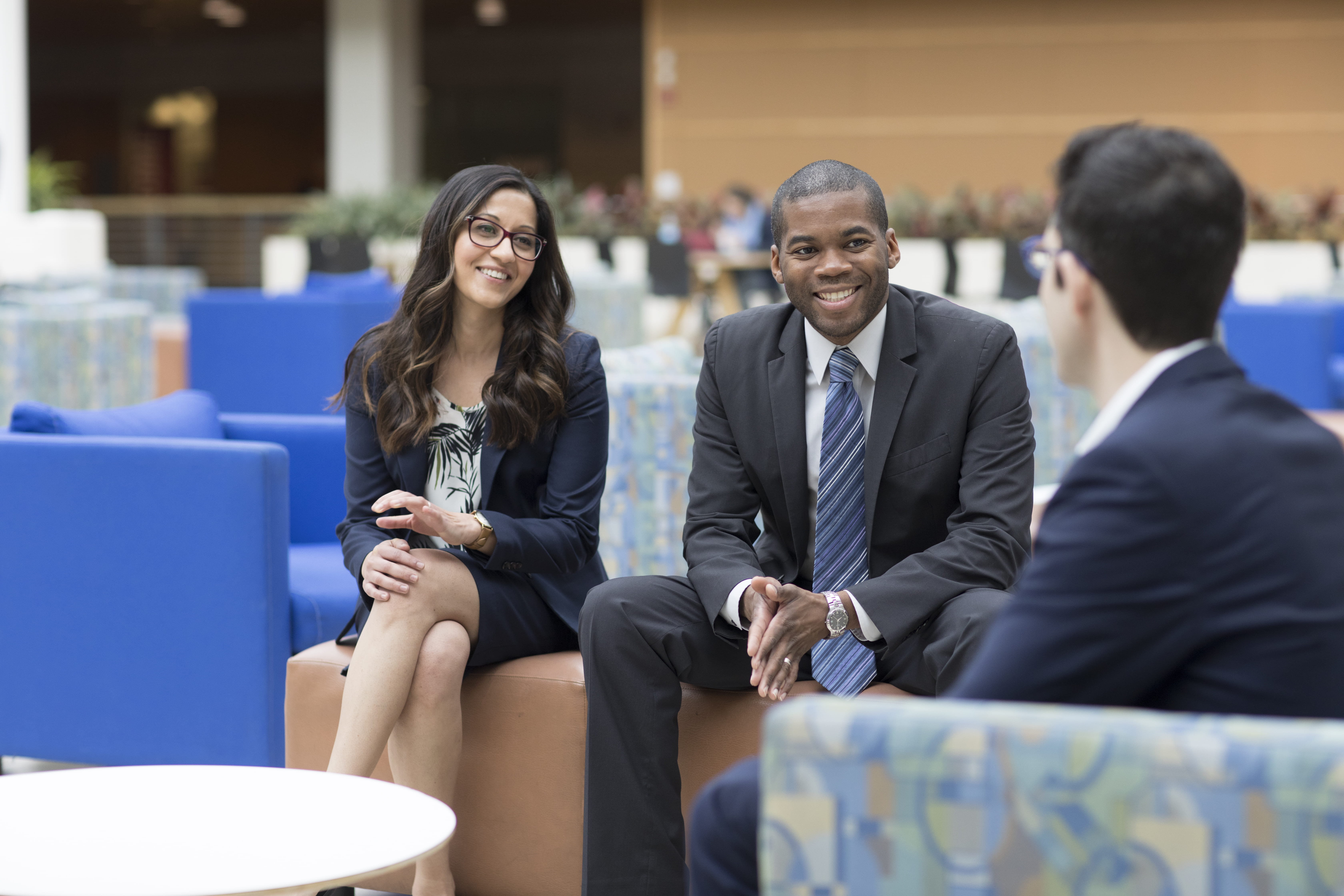 Three business students sitting together and talking