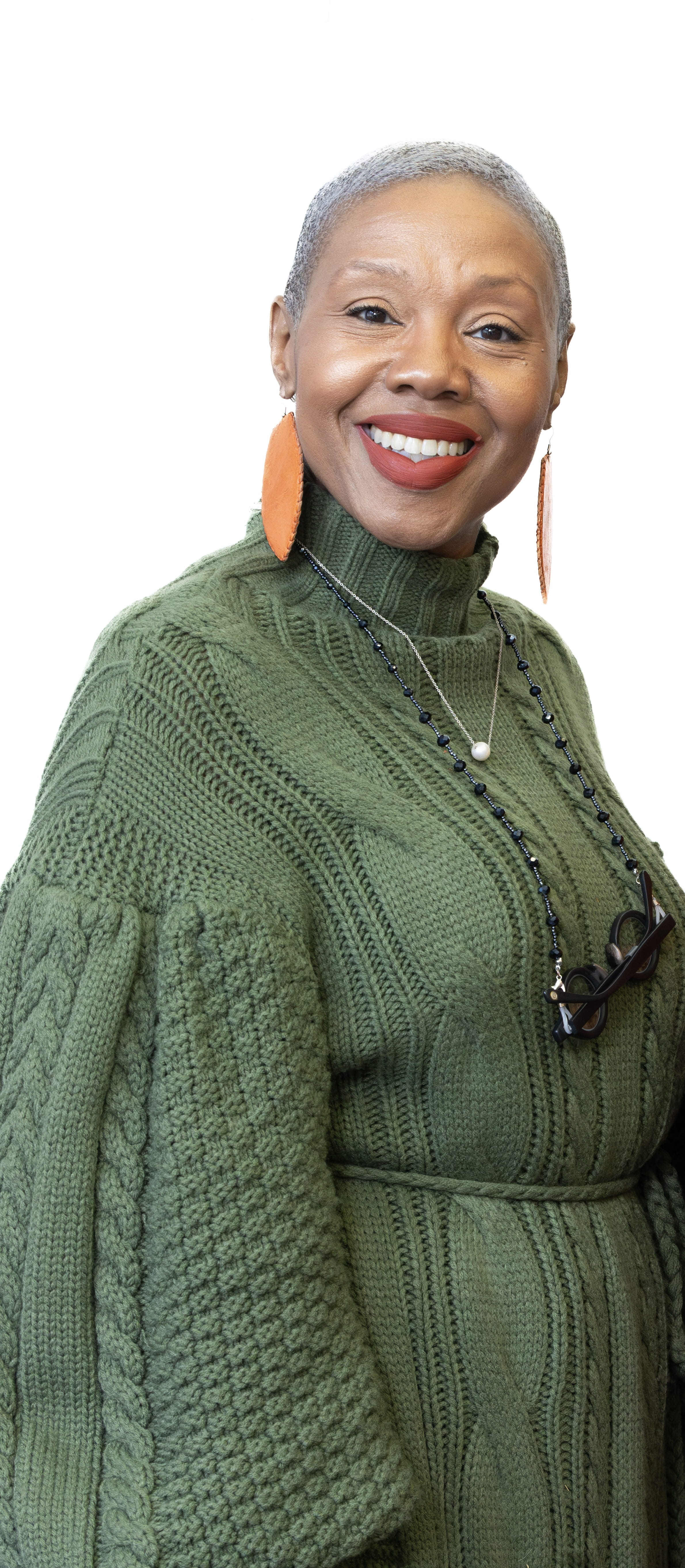 Woman wearing a green dress smiling at the camera