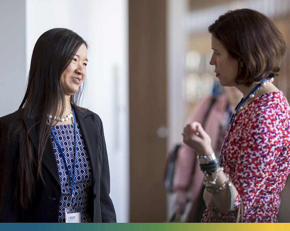 Michelle Cronin, left, talks with a colleague during the Rustandy Center’s On Board conference