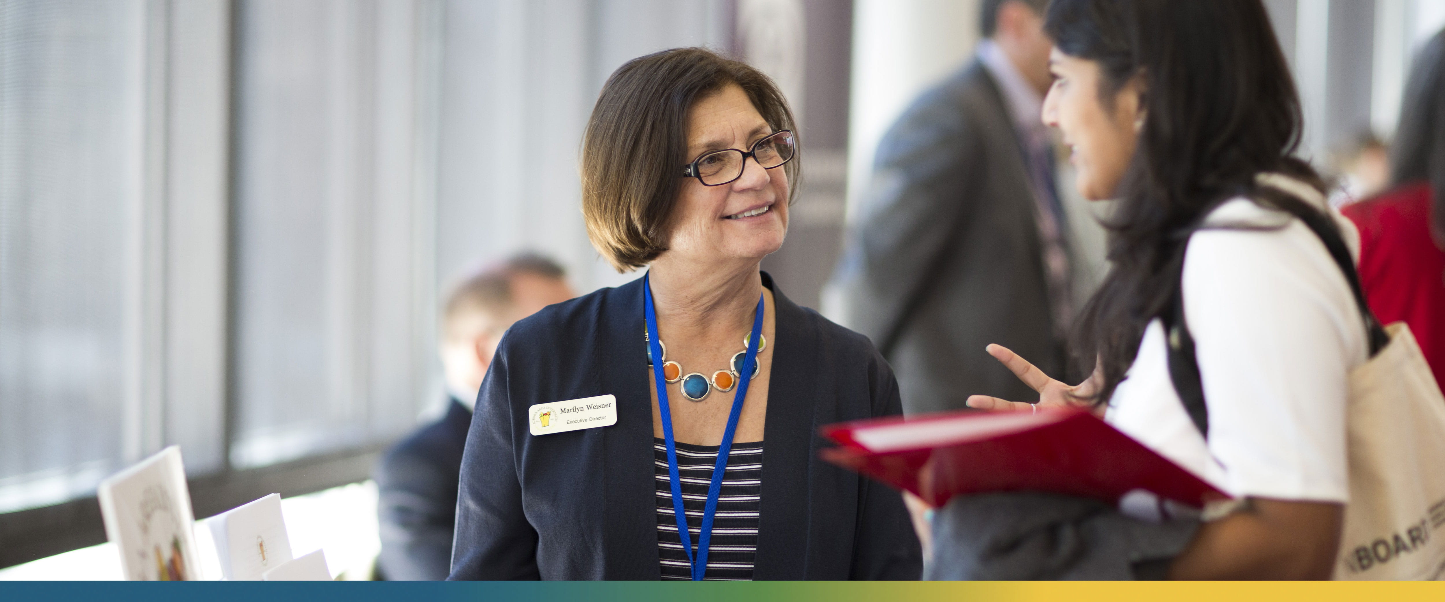 Two women chatting at Rustandy's On Board event