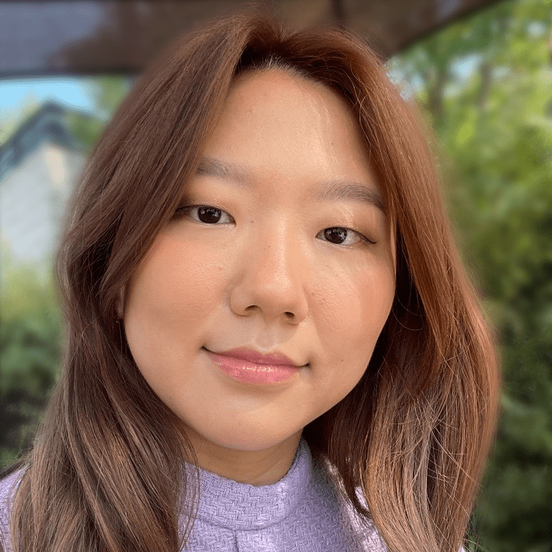 A woman with long hair looking at the camera