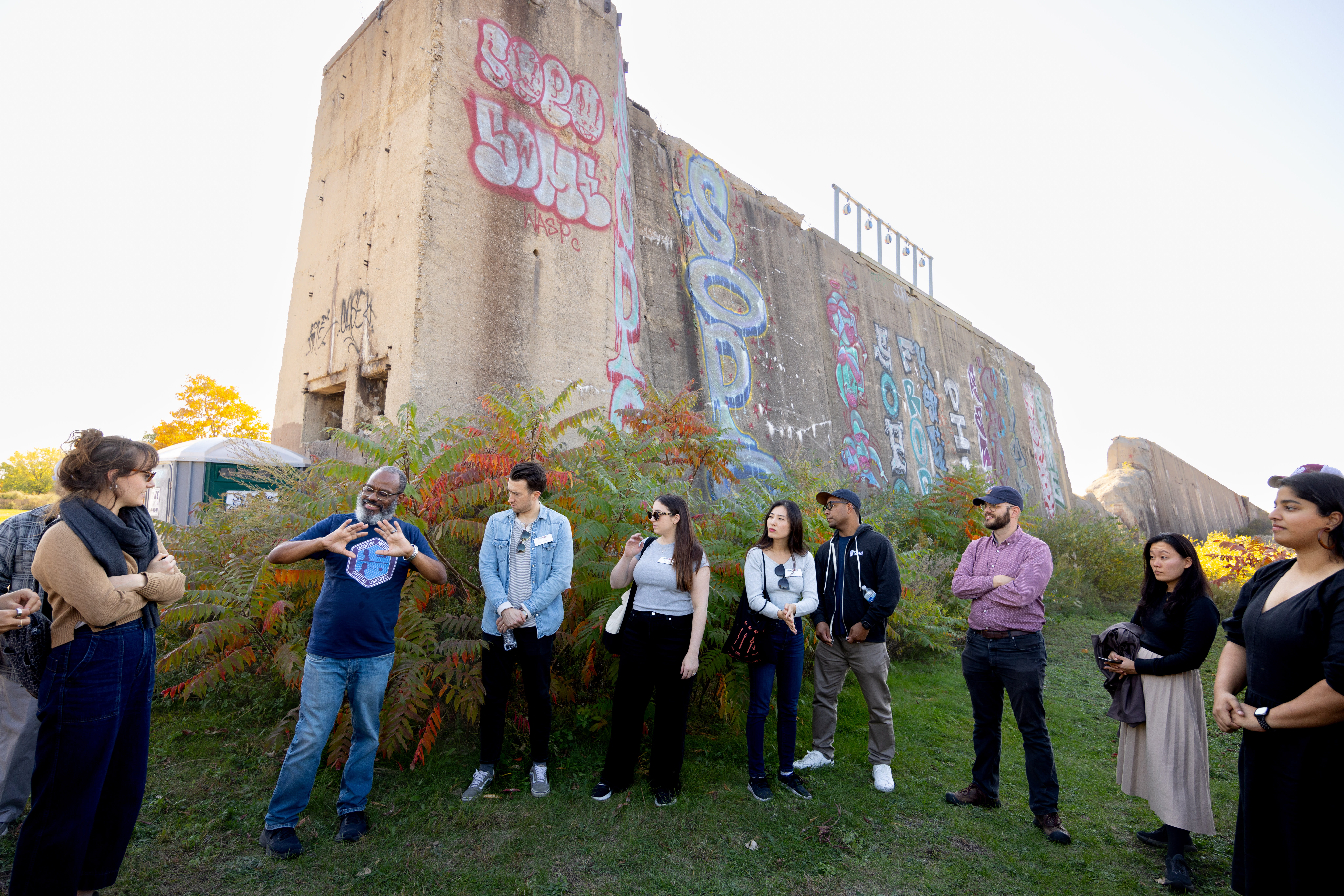Nine people standing in front of an old building