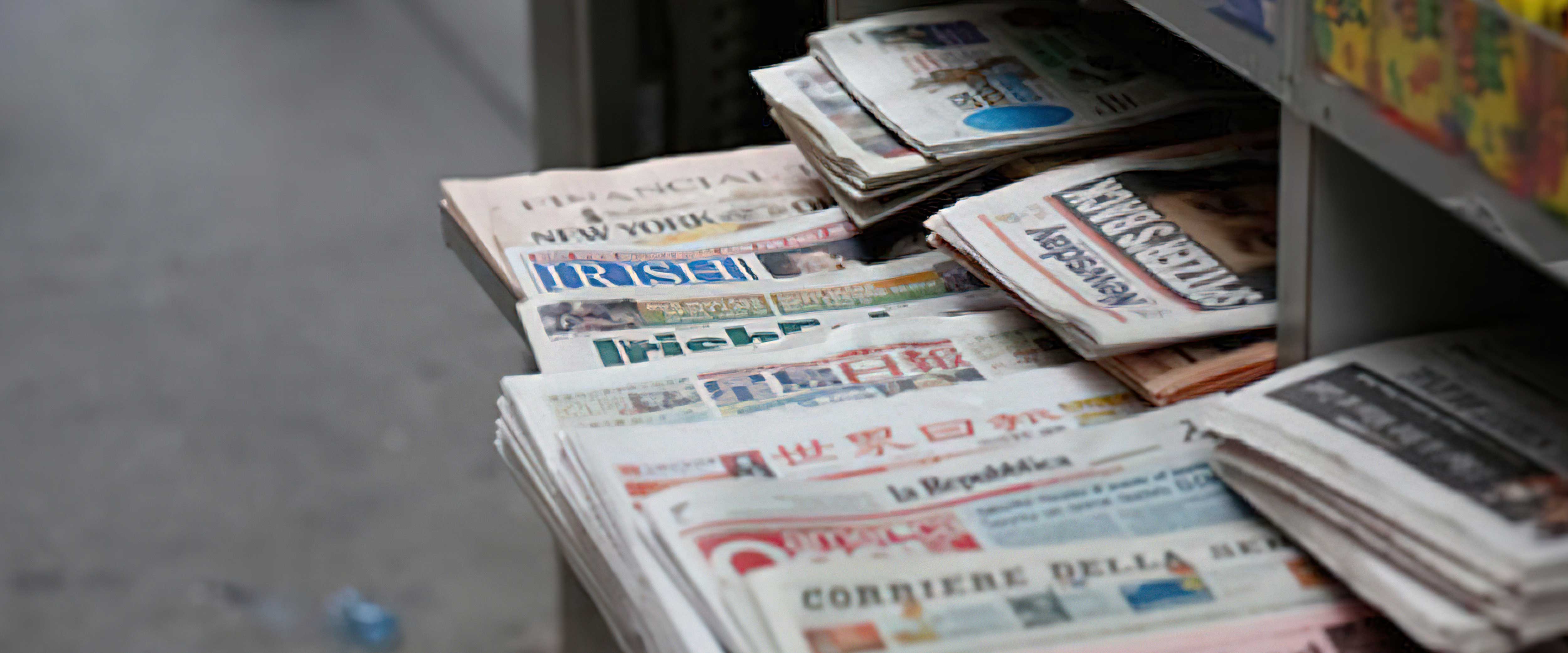 Stack of newspapers at kiosk