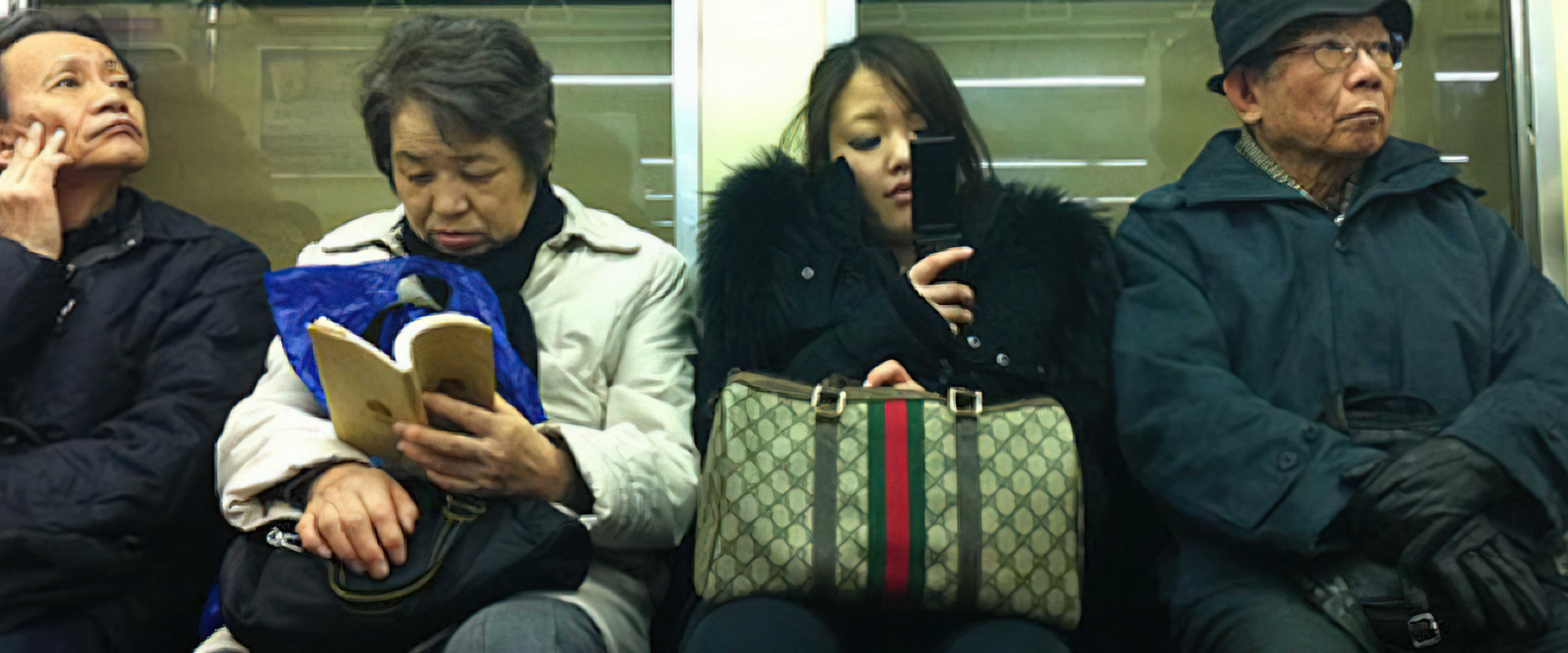 People sitting together closely on train