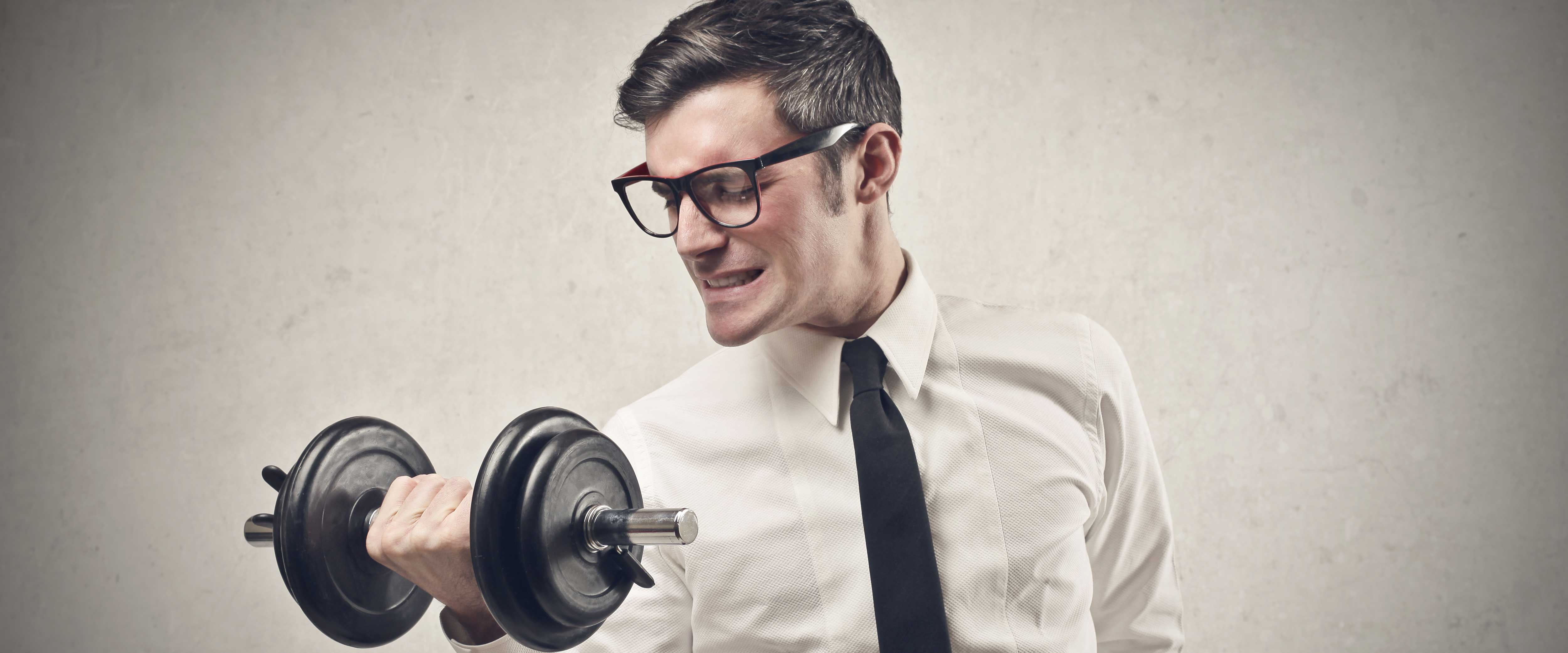 Man in dress shirt lifting curling weights