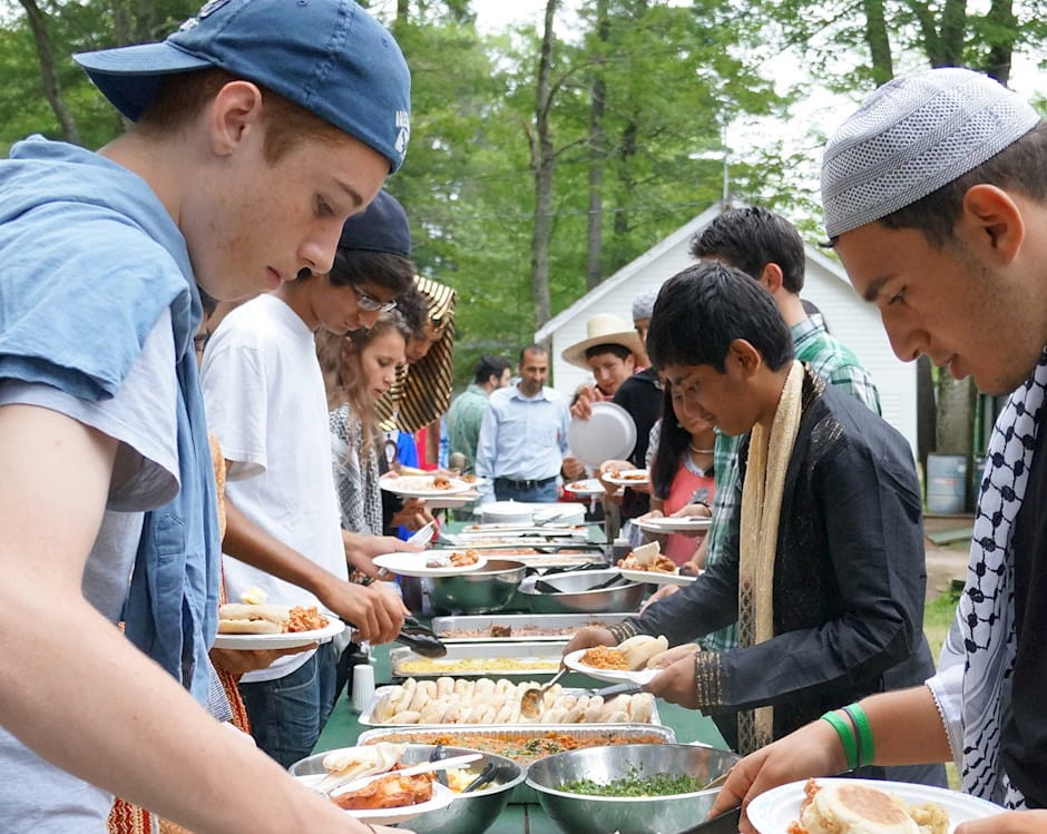 Teens at summer camp getting food