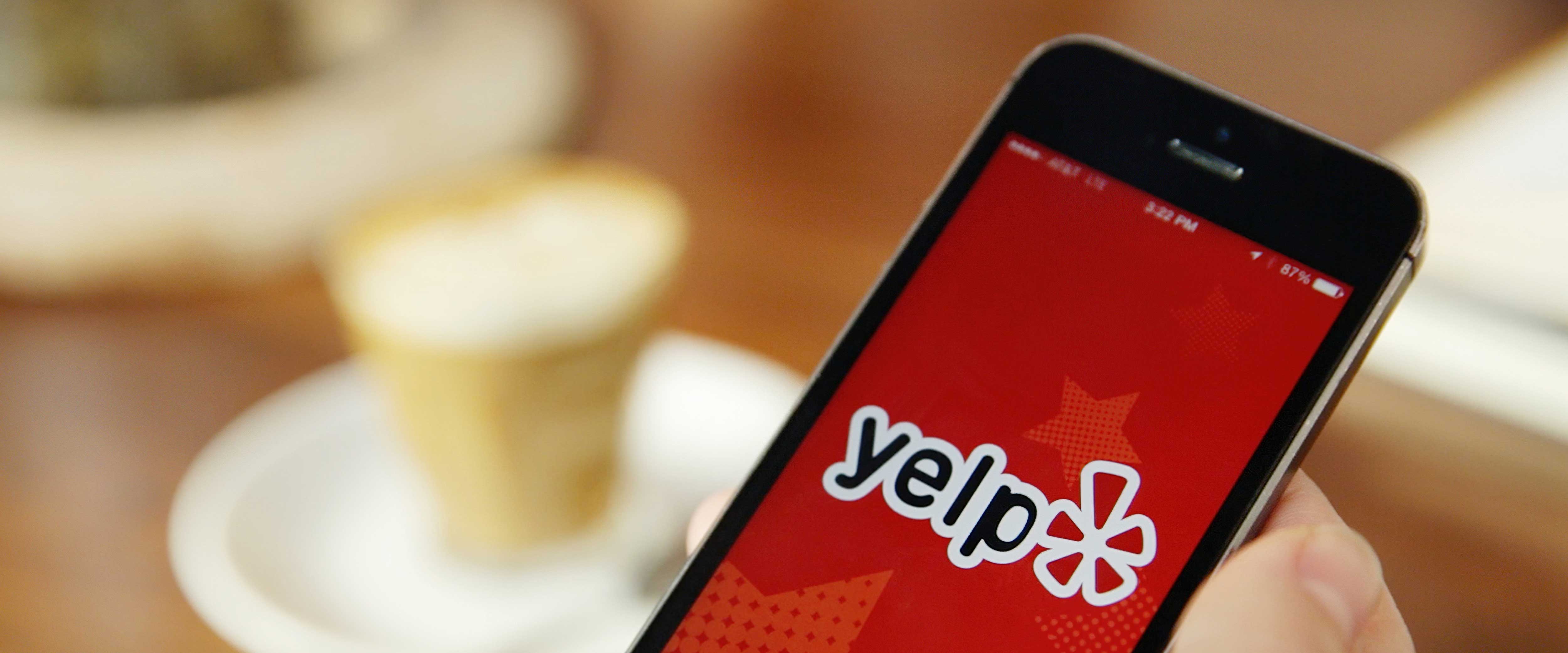 Smartphone with Yelp app open