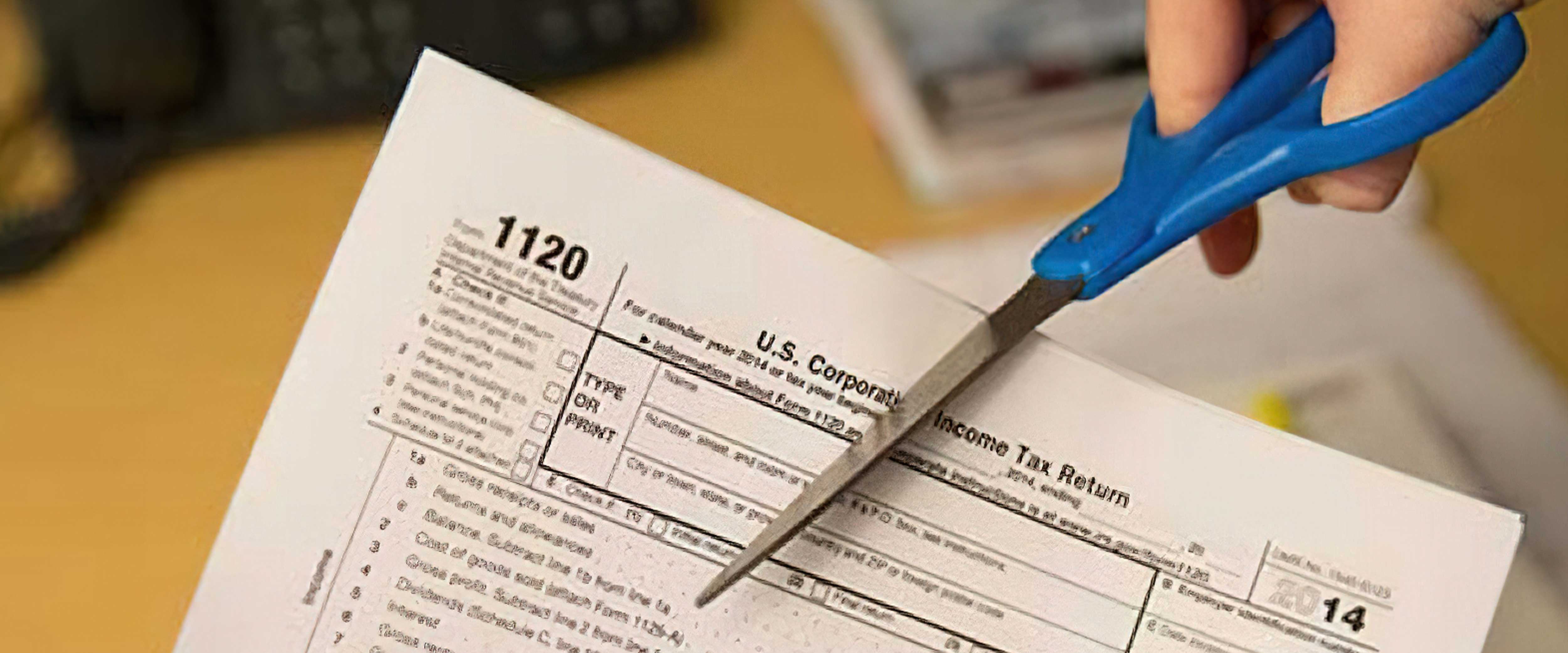 Tax form being cut with scissors