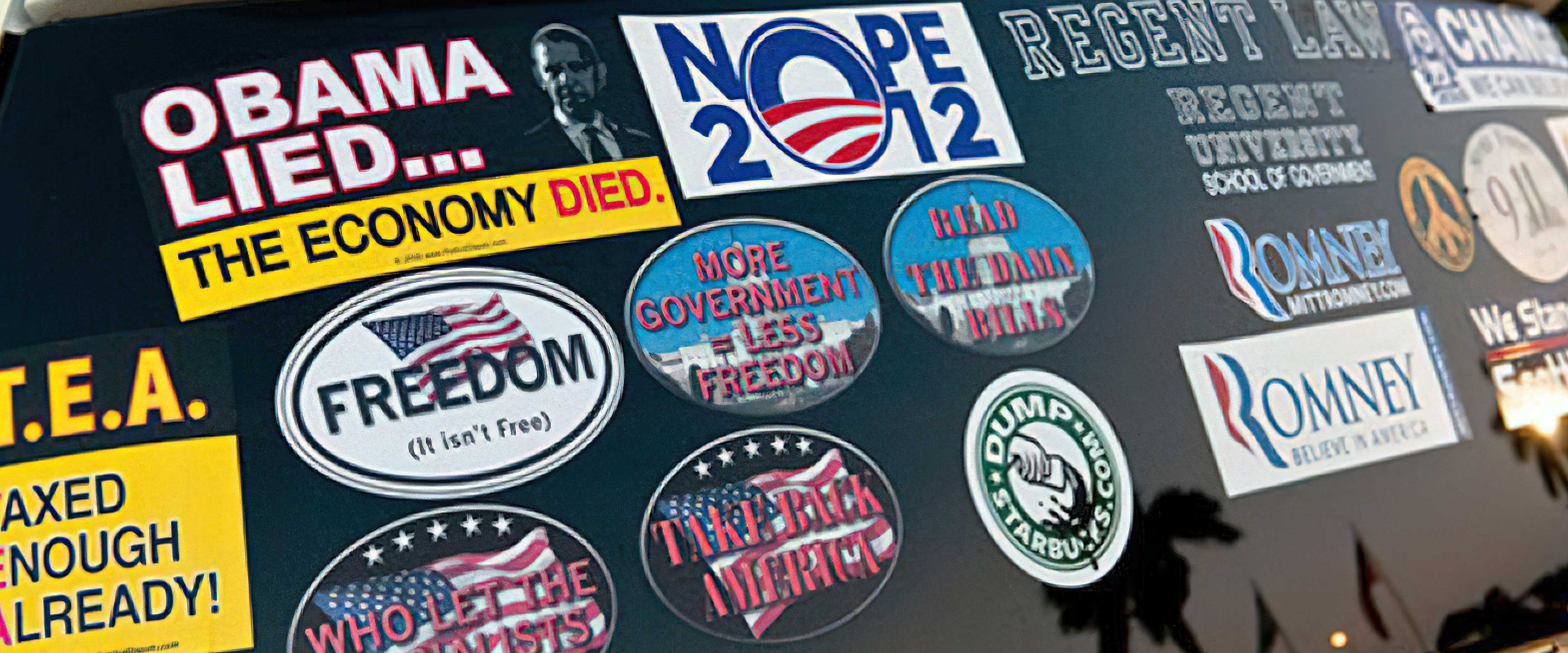 Car window covered in political bumper stickers