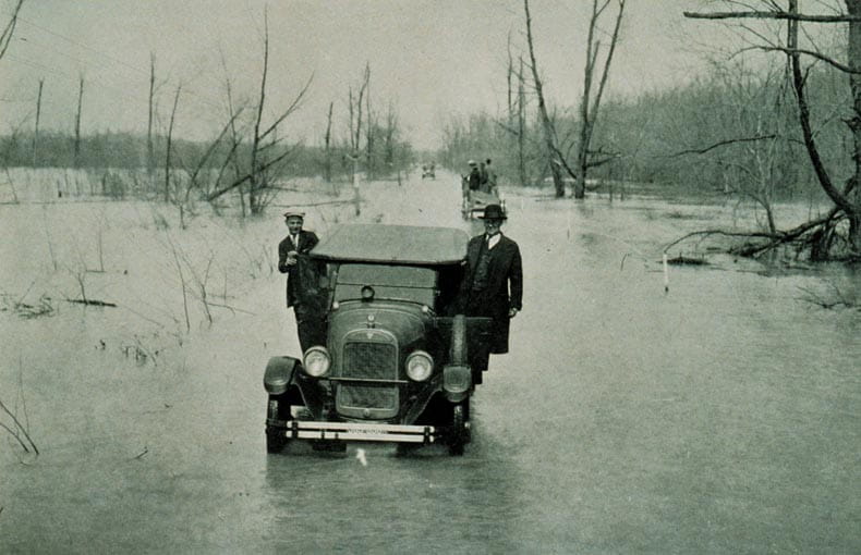 Vintage car driving through flooded Mississippi River in 1927