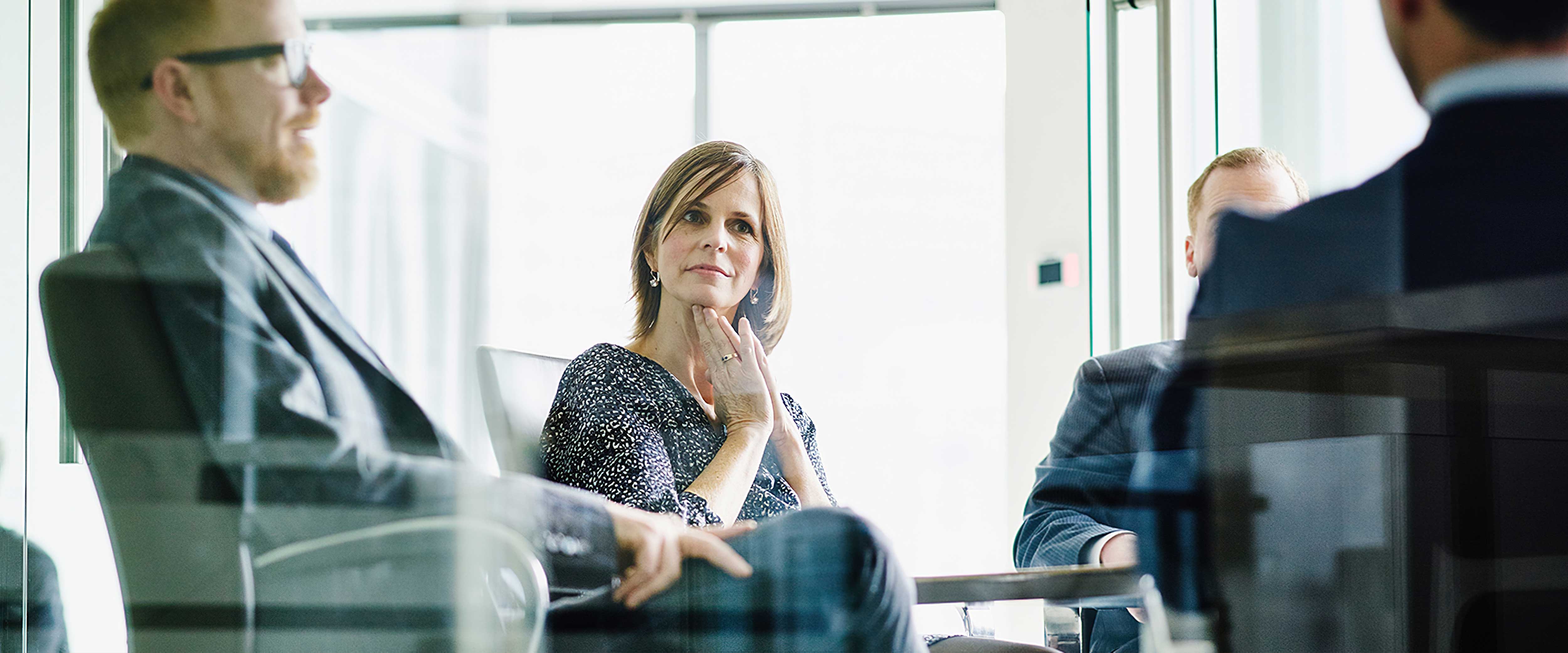 Woman in meeting filled with men