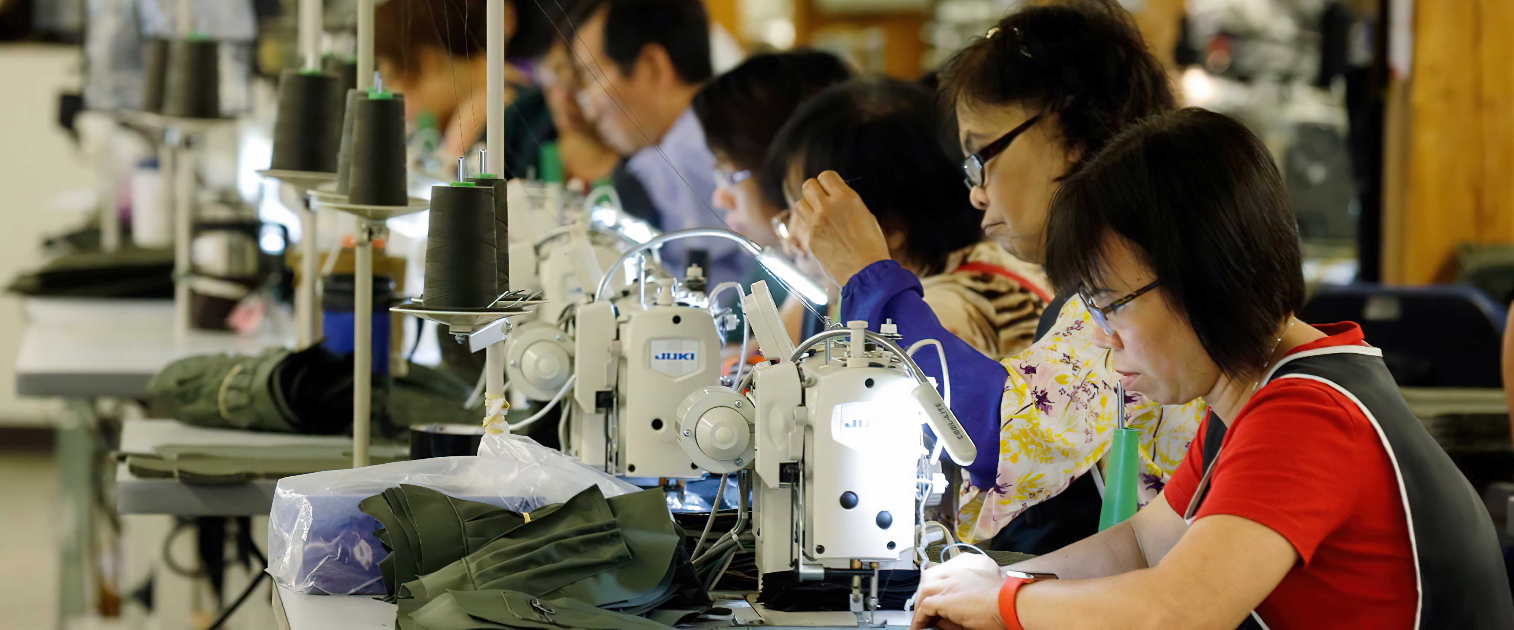 Laborers working on sewing machines