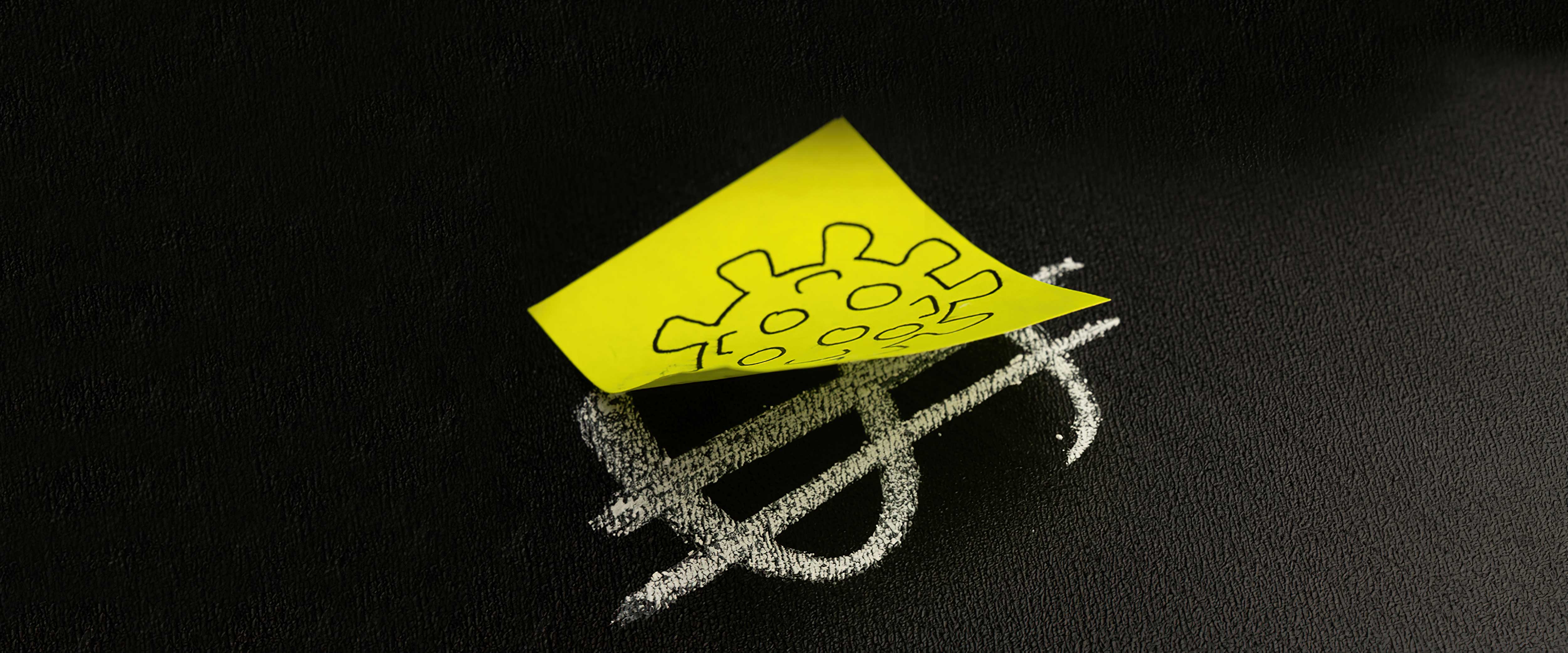 Dollar sign with a post-it note on top with a covid ball