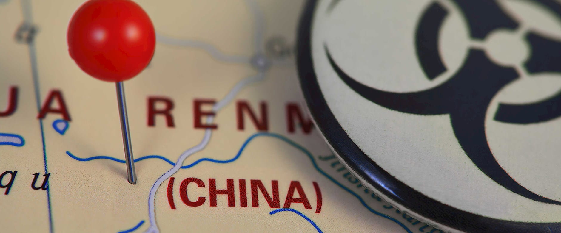 Map of China with a pin in it with quarantine symbol disc on top