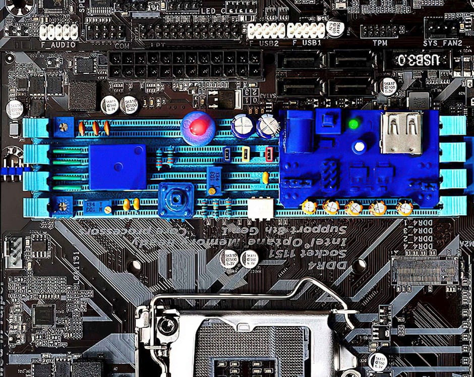 Black and white motherboard with a color component syringe in the center