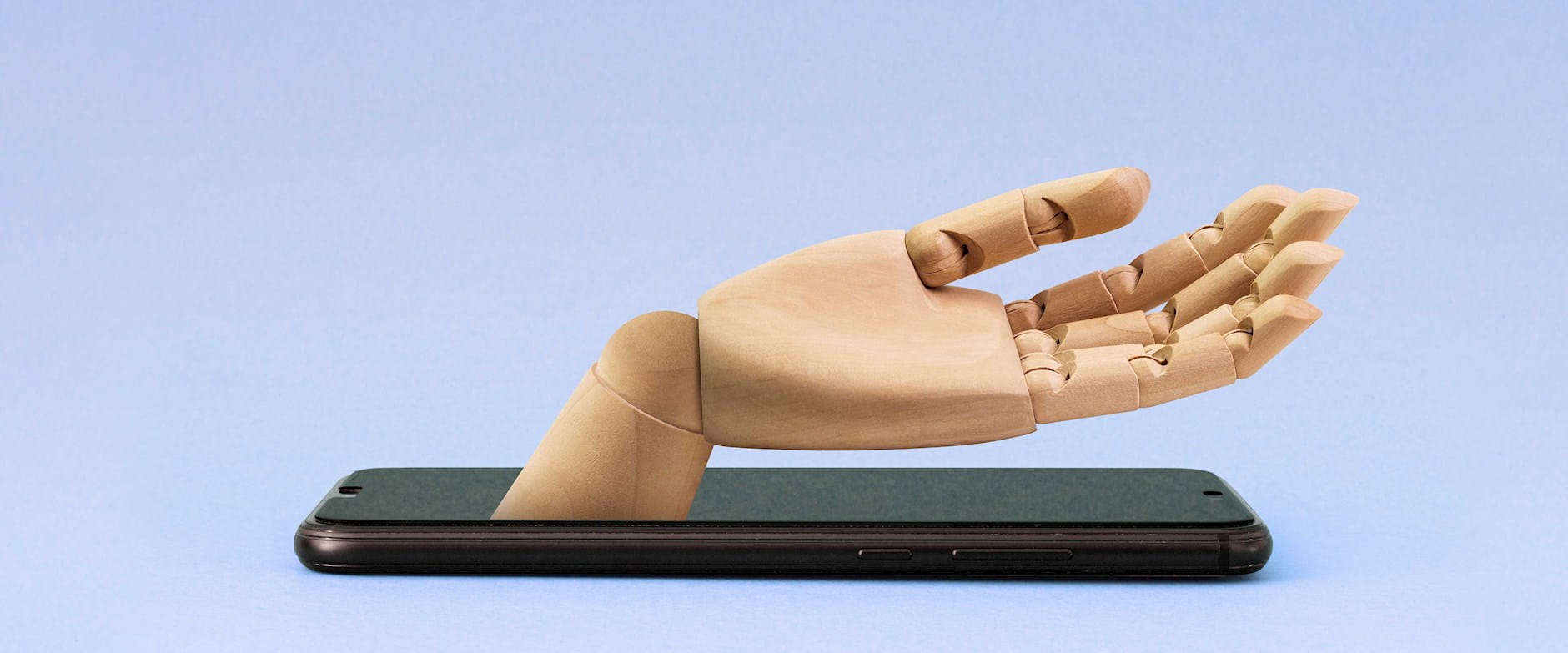 Wooden hand emerging from smartphone