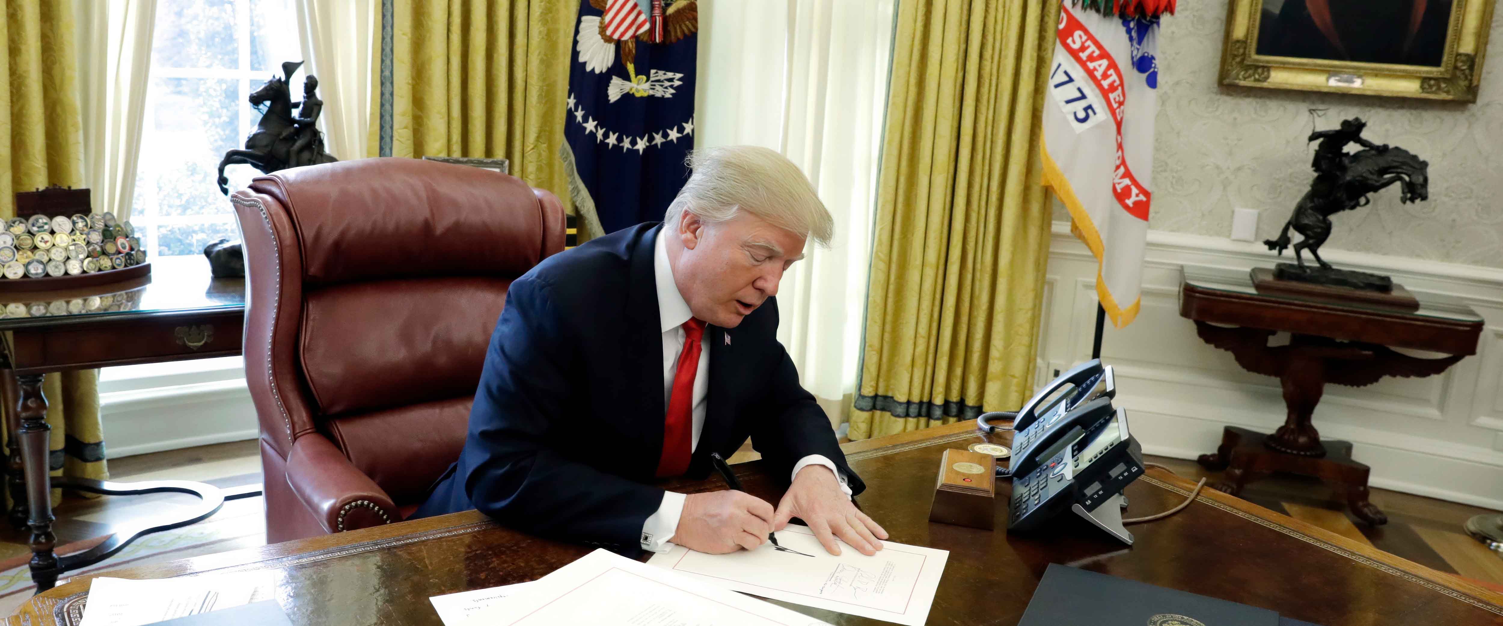 Donald Trump signing a bill into law
