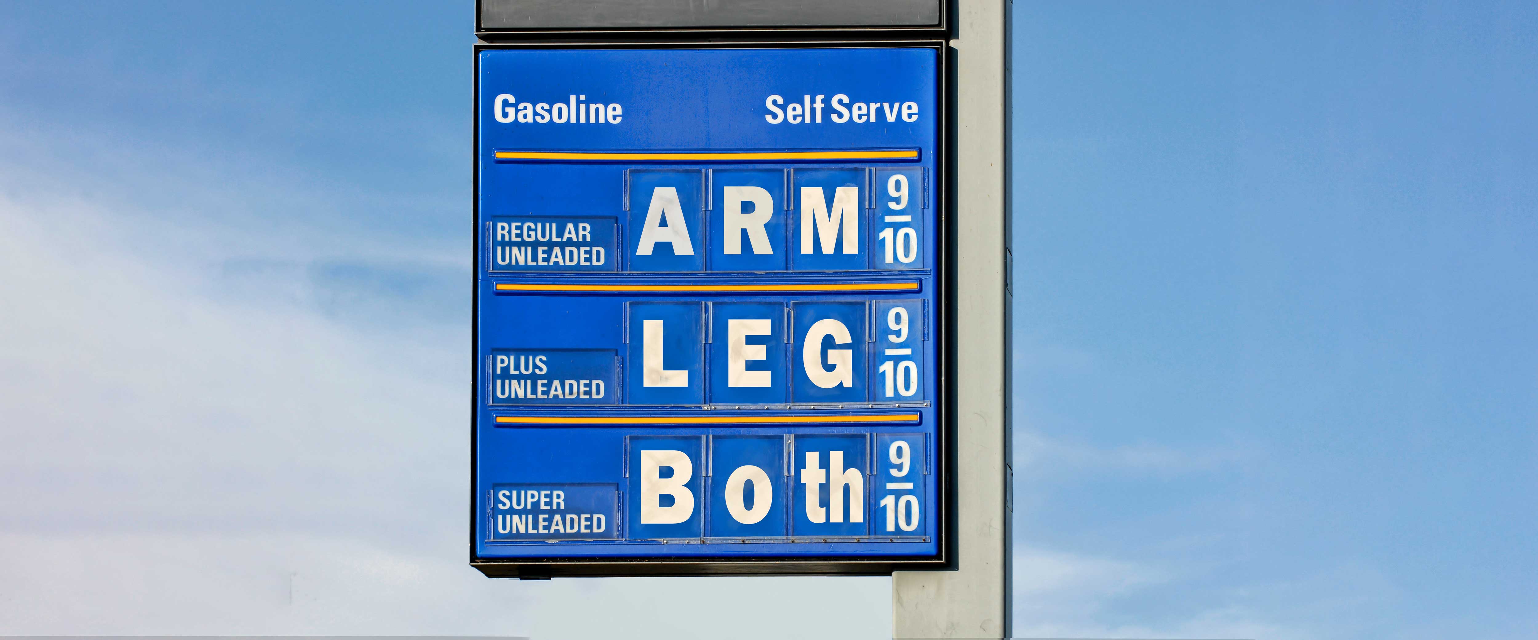 Gas station sign with prices including "arm" and "leg"