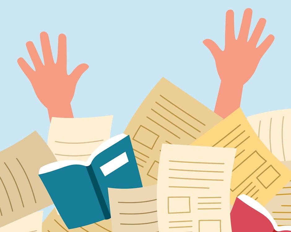 Hands reaching up from pile of books and papers