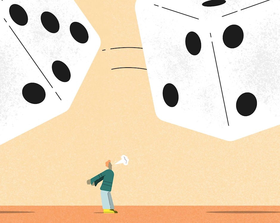 Person blowing on giant dice