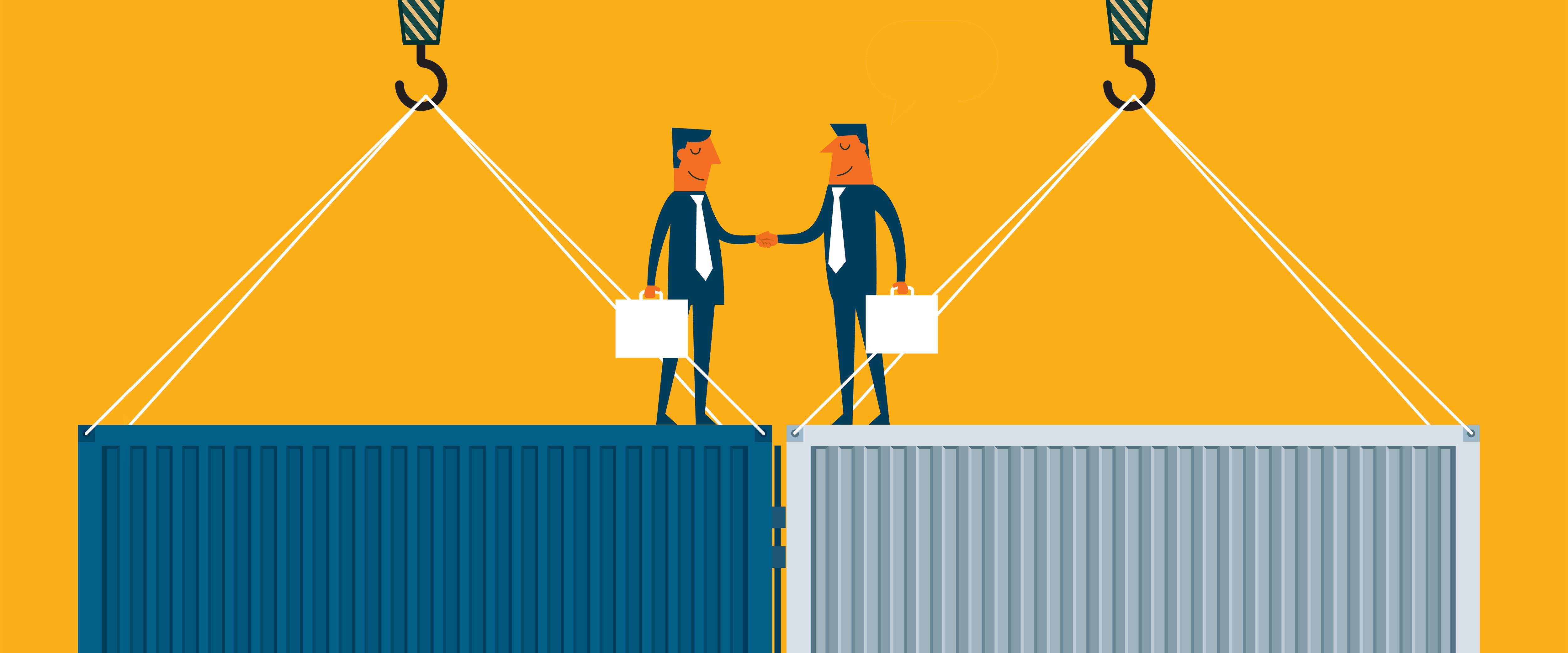 Businessmen shaking hands atop shipping containers