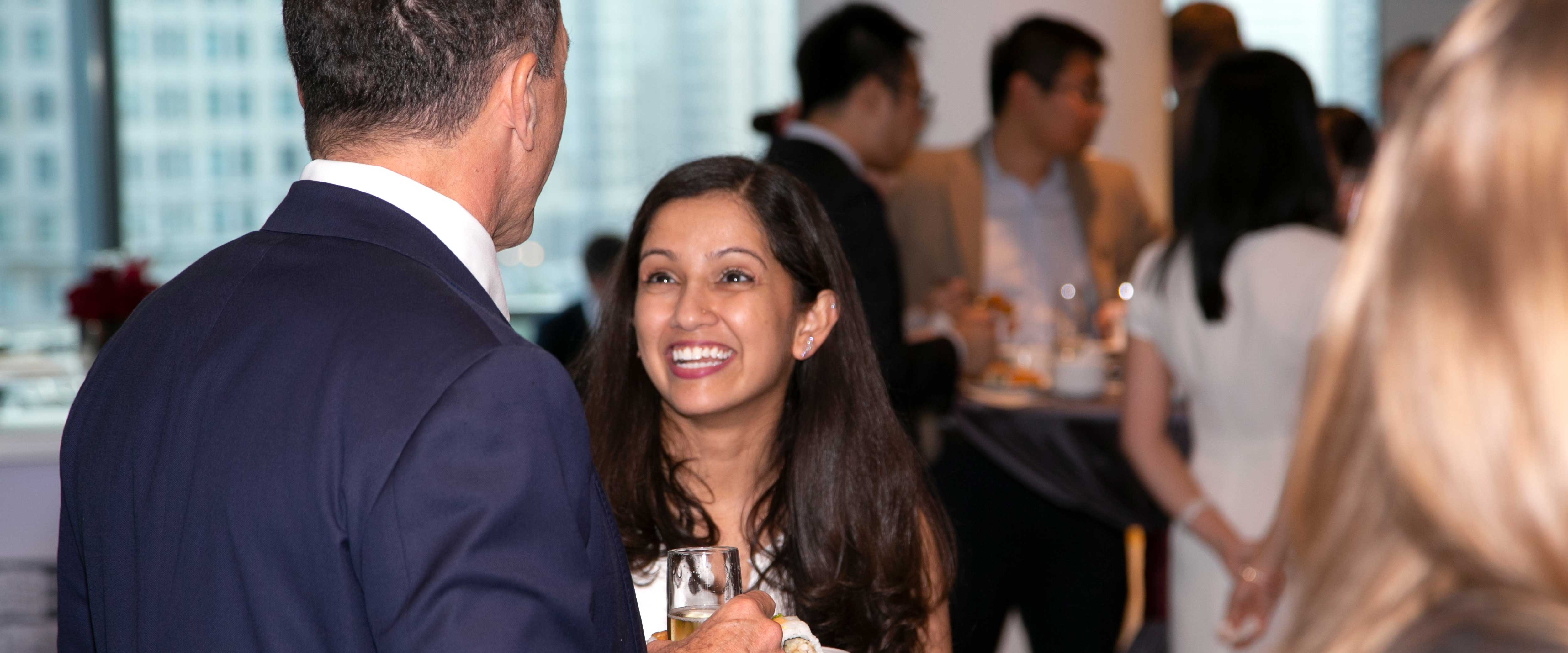 A student speaking to a man at an event