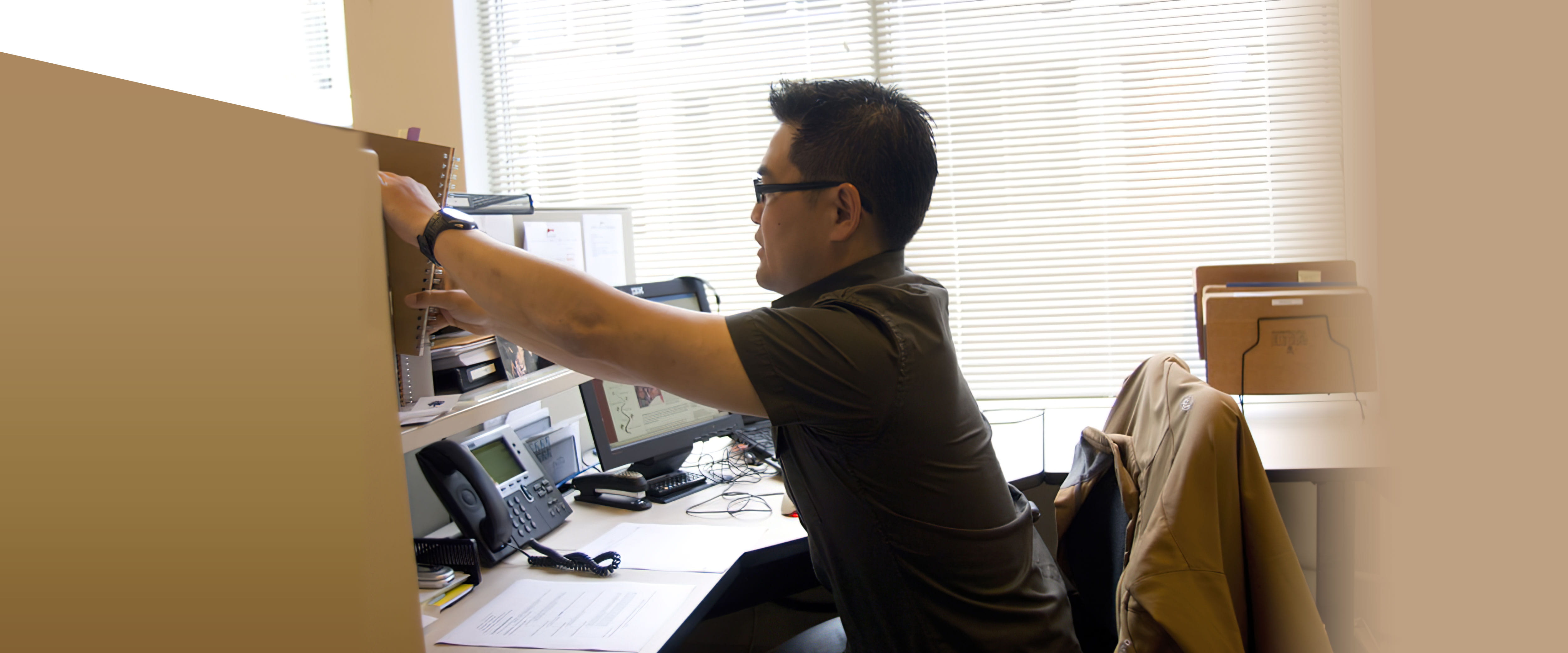 Craig K. Nakagawa working at his desk