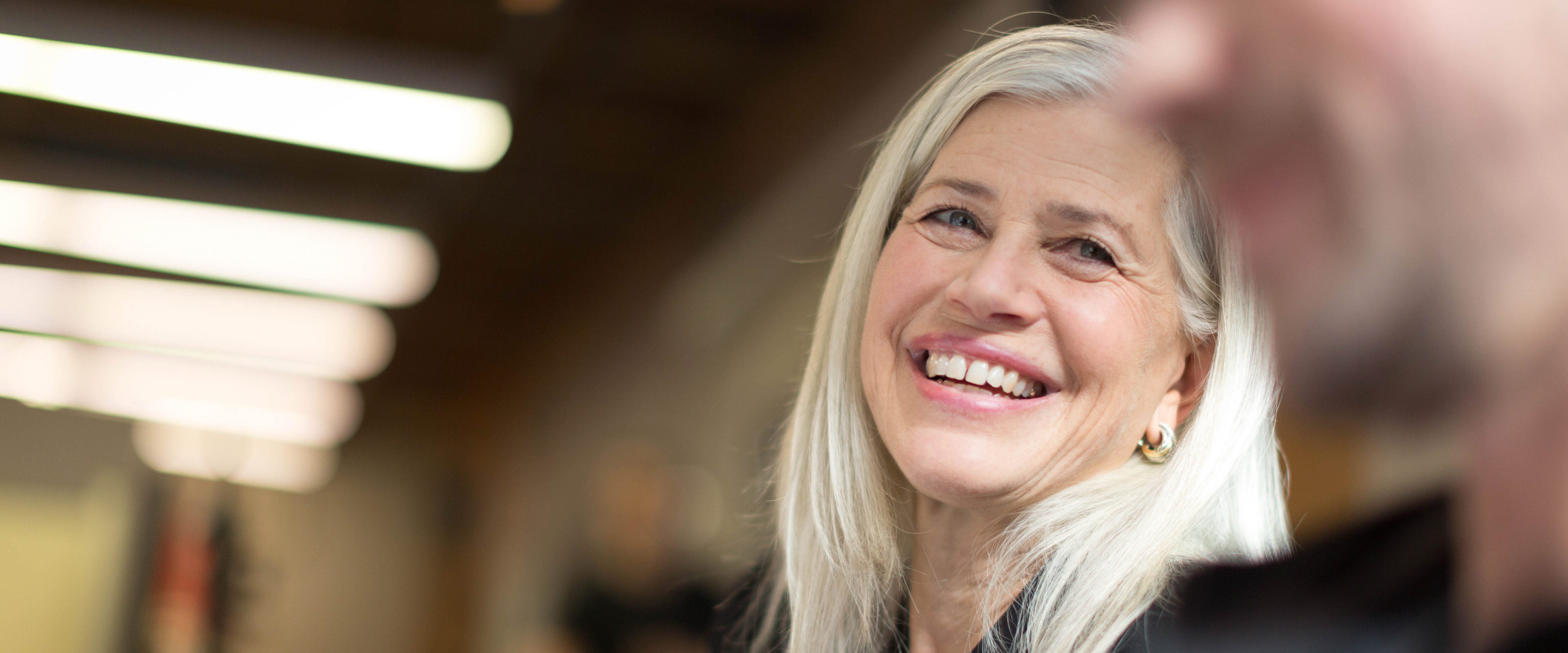 Susan L. Axelrod smiling in a conversation