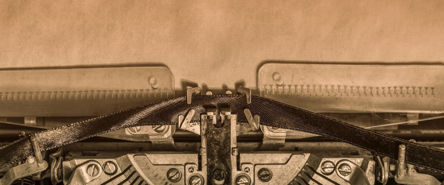 Closeup of a typewriter with old paper in the background